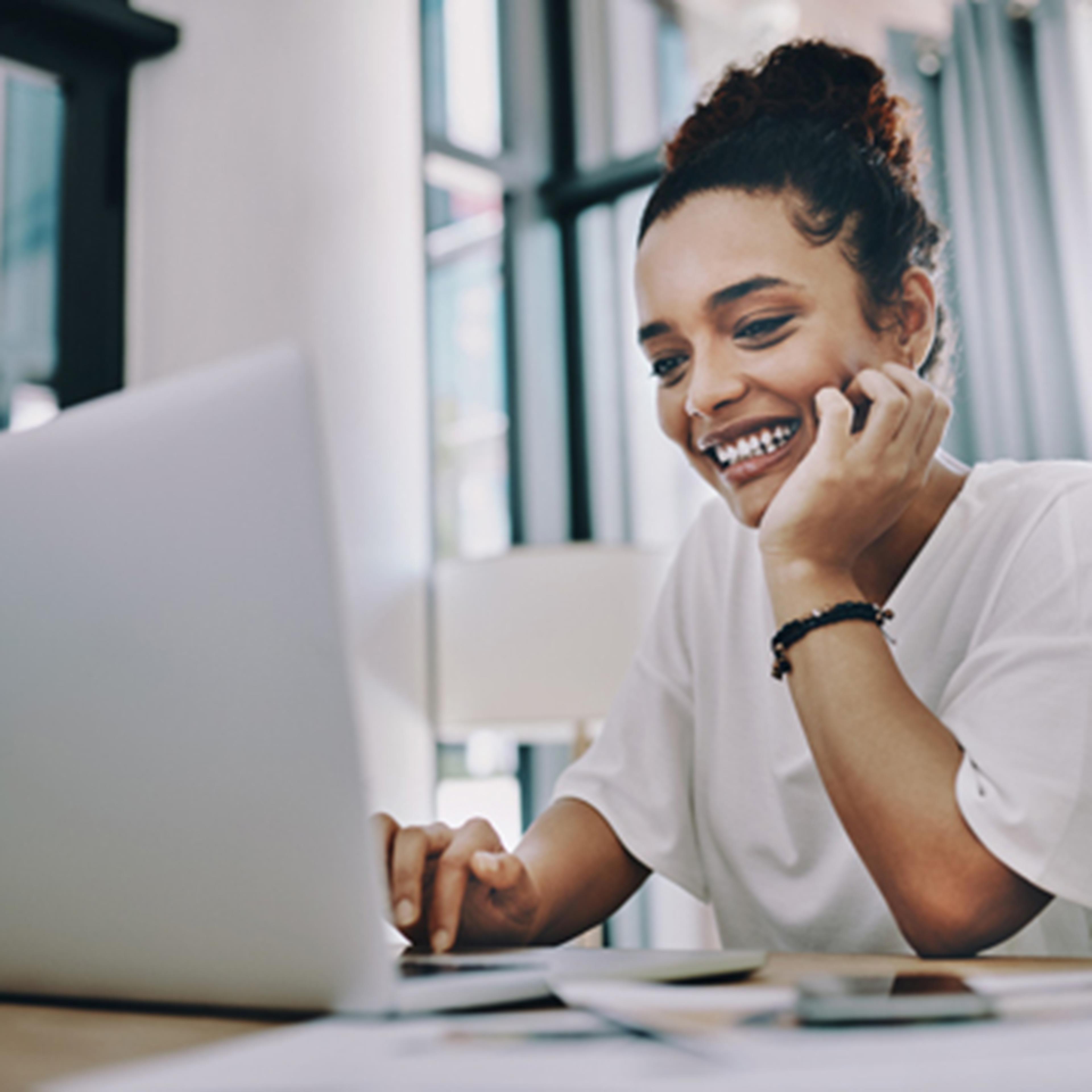 Woman smiling at laptop