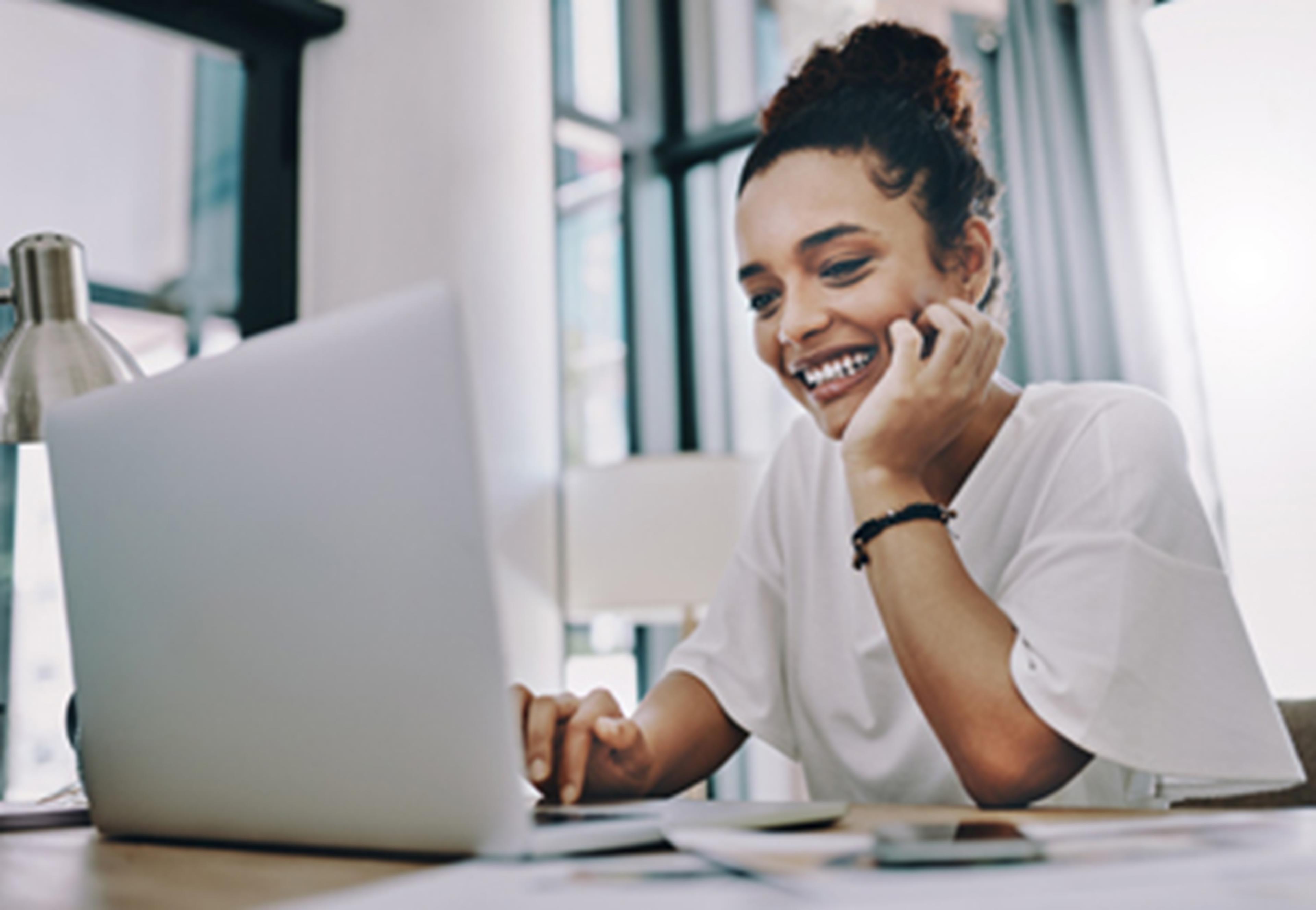 Woman smiling at laptop