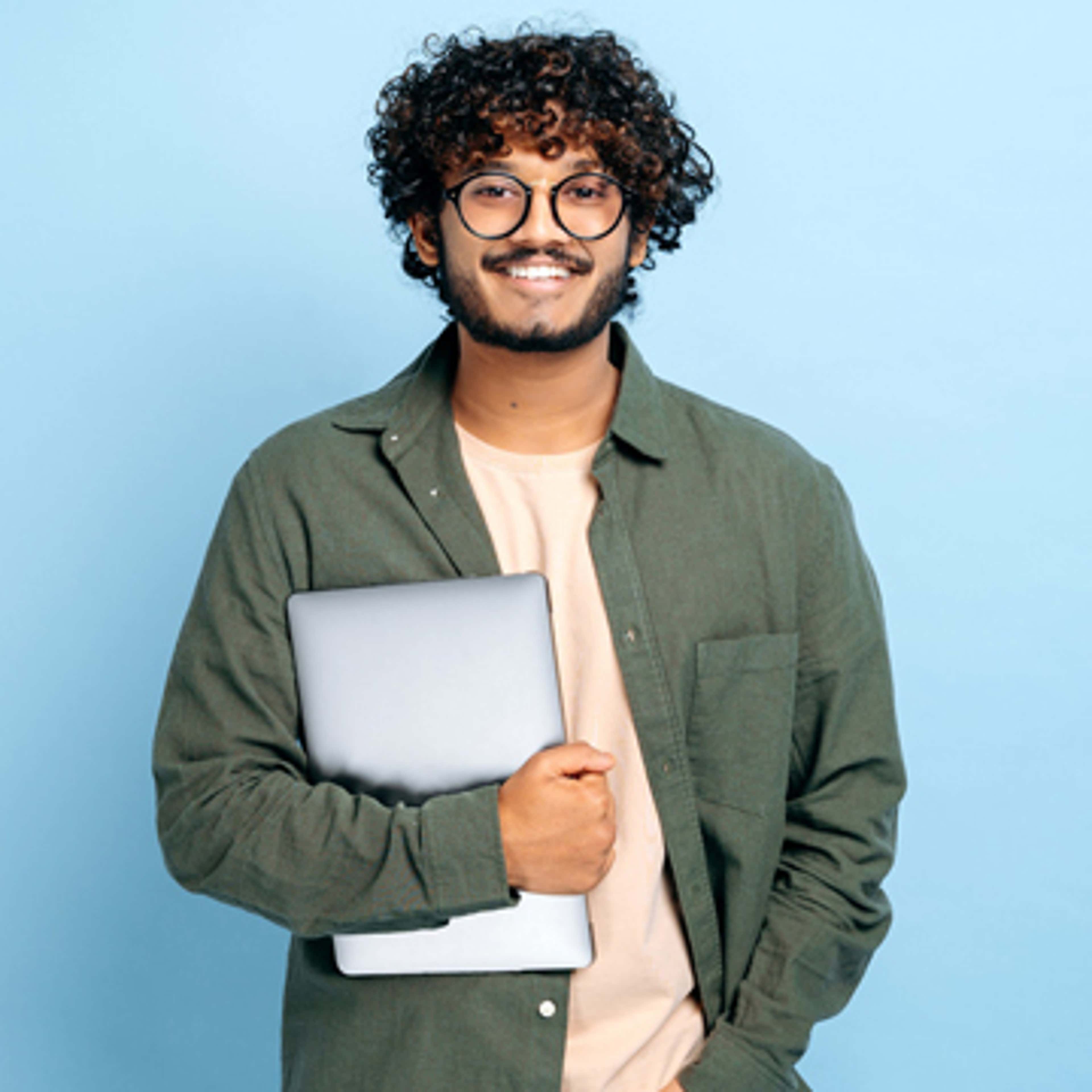 Man smiling with laptop in hand