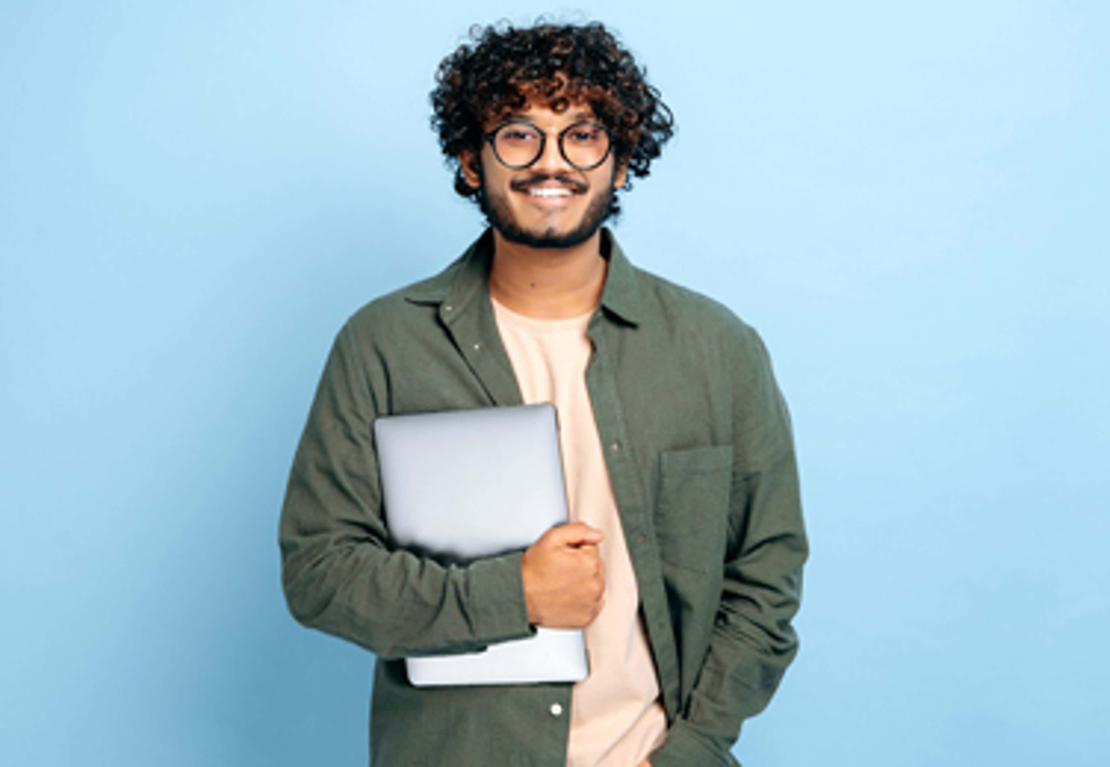 Man smiling with laptop in hand