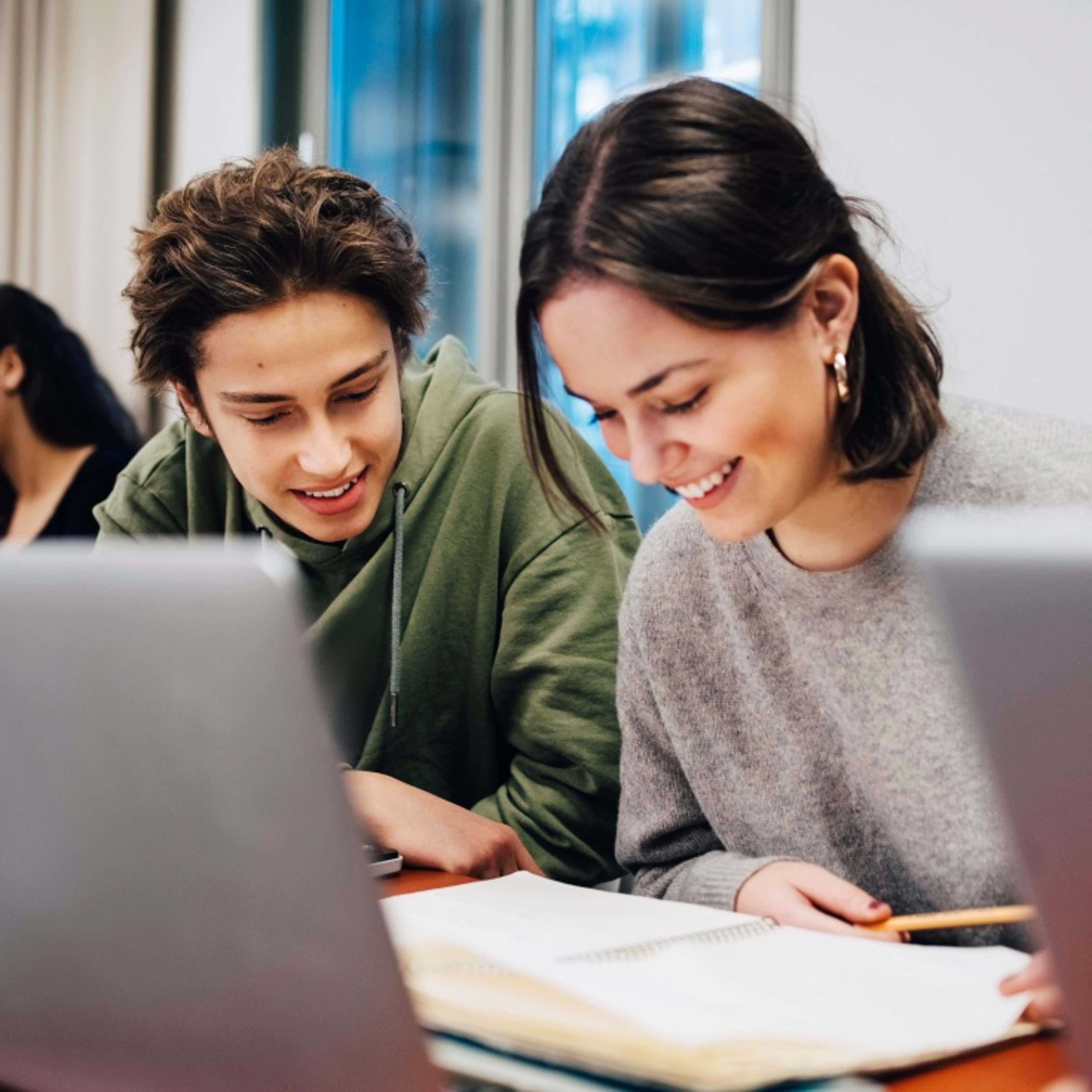 Person laughing showing laptop