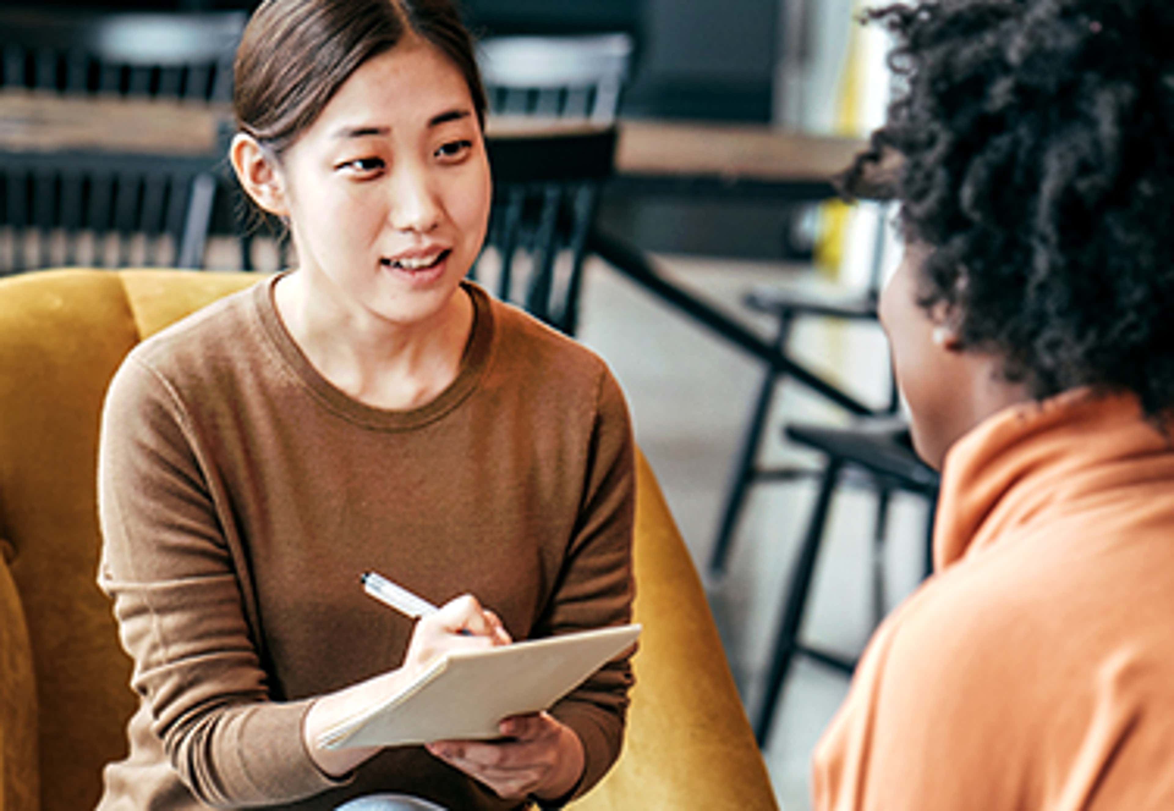 Two people sitting talking to each other