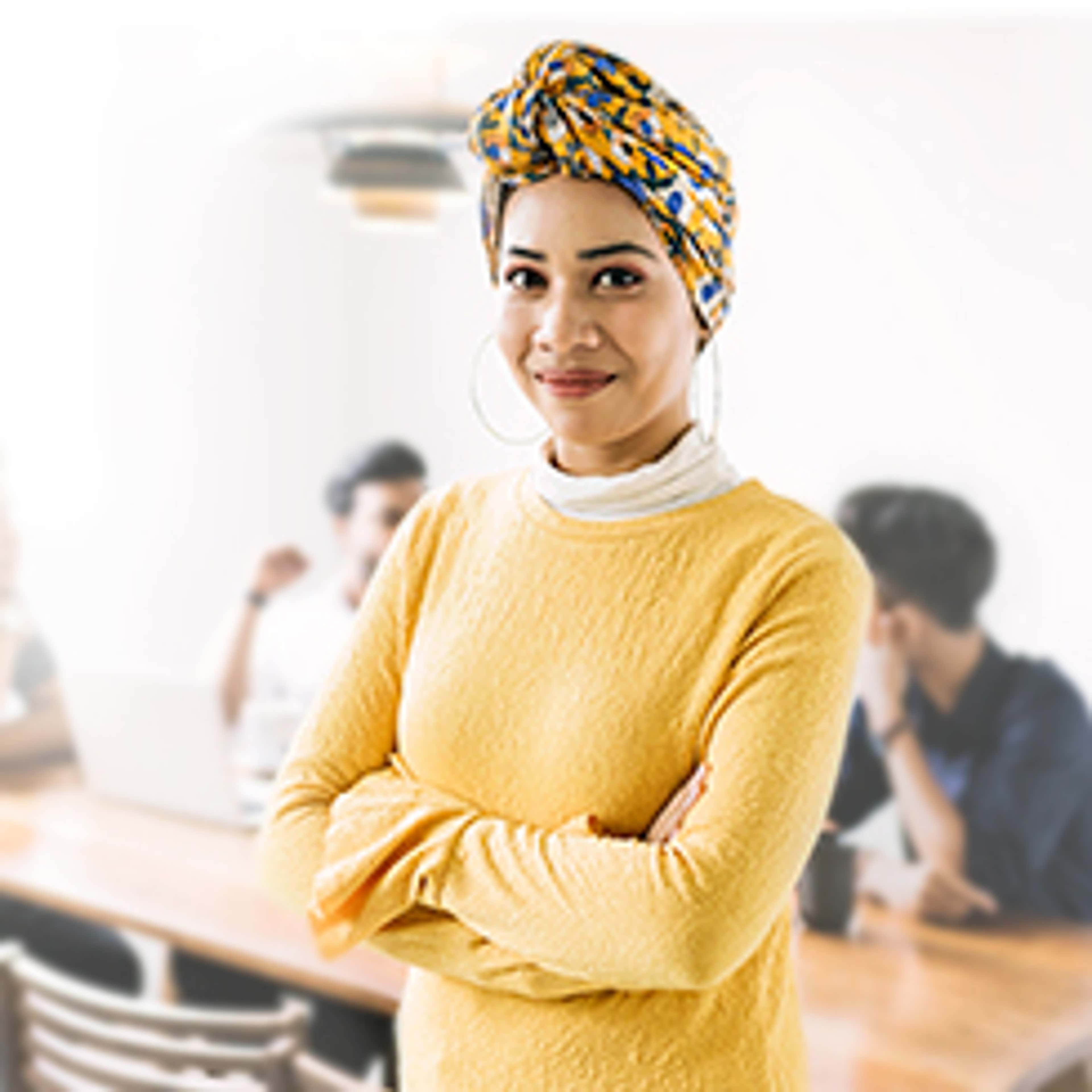 Person with yellow shirt looking at camera and smiling
