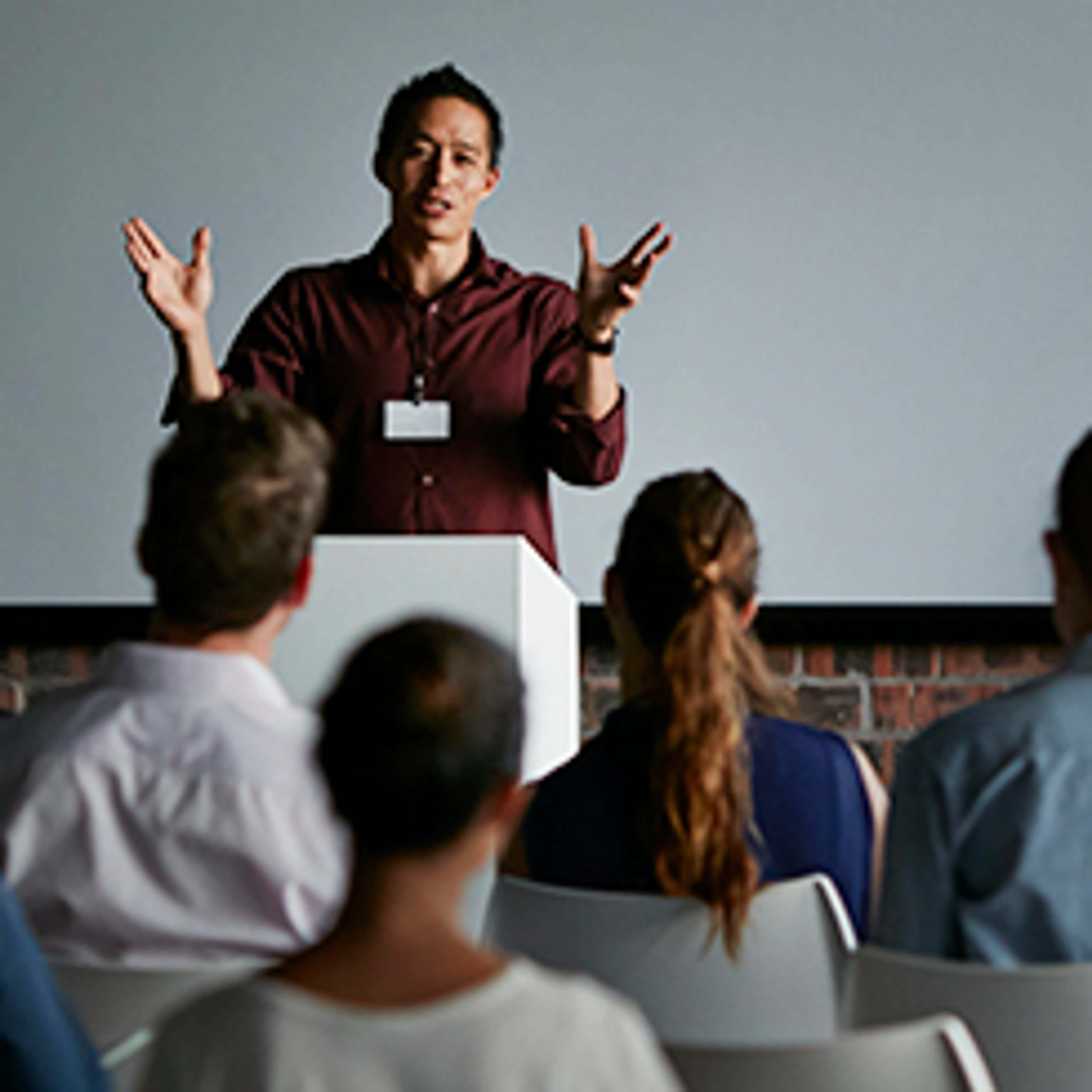 Person standing at front of classroom teaching