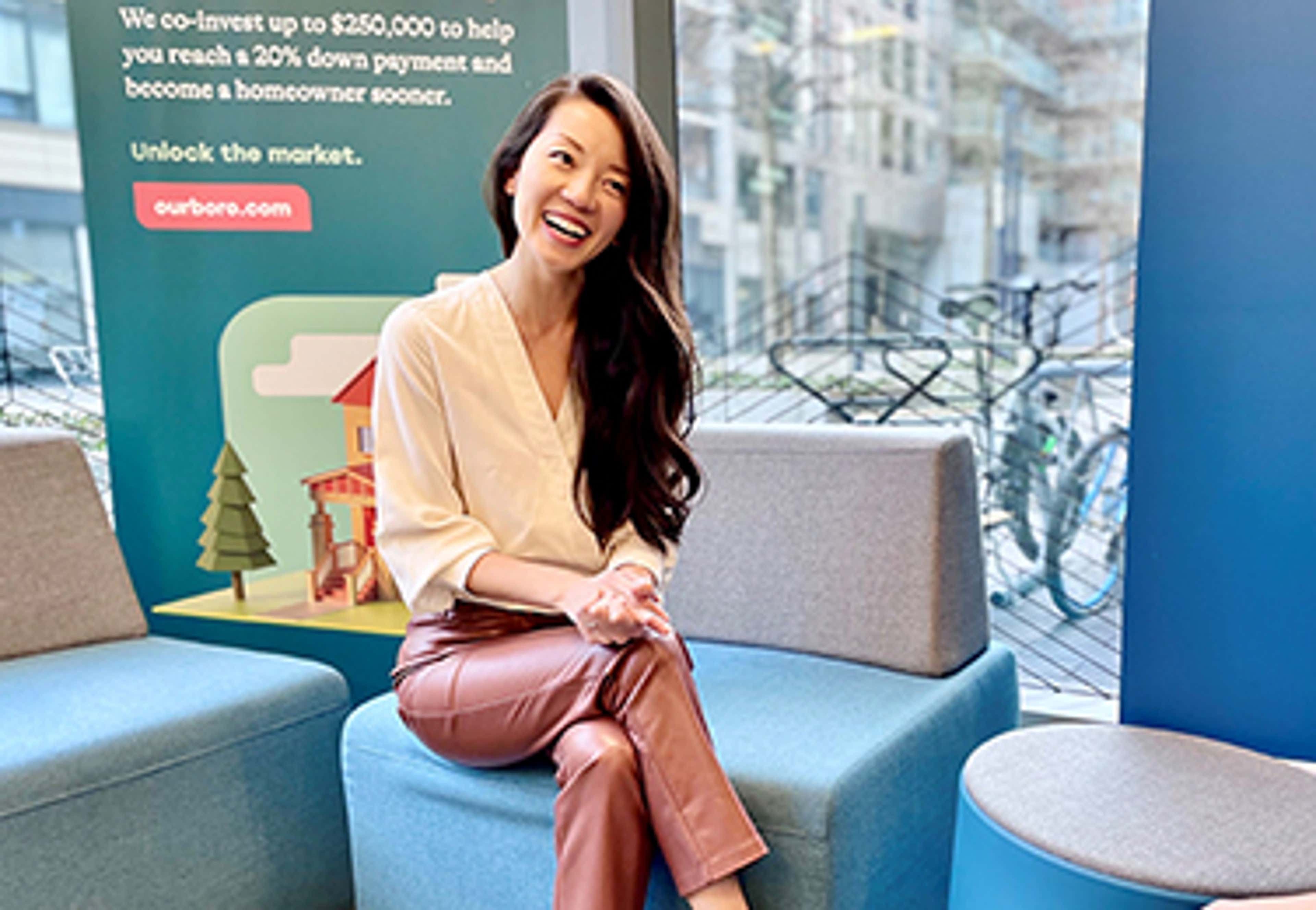 Alex sitting on a chair, smiling