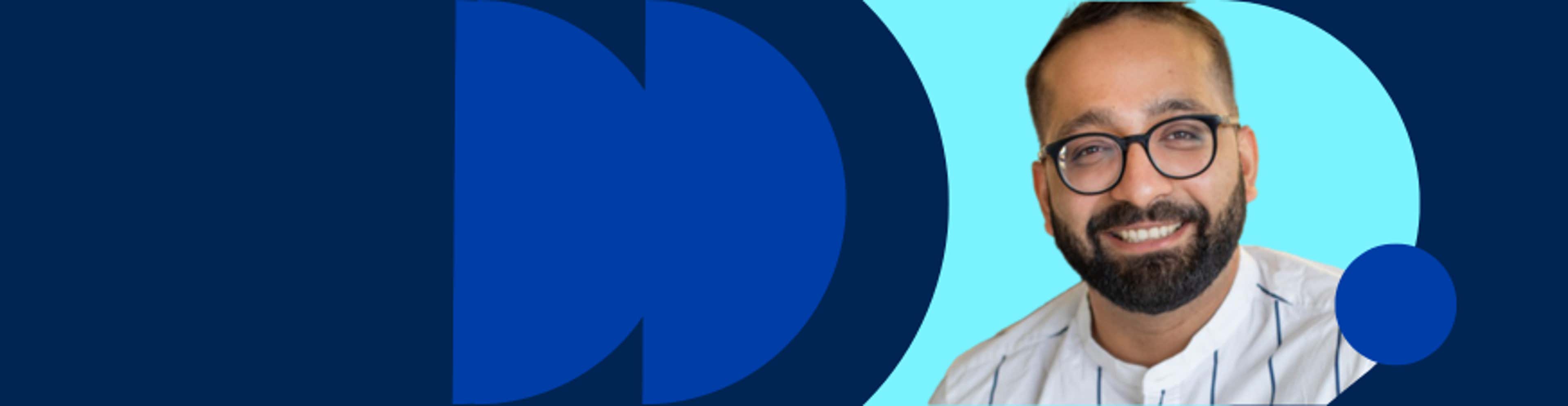 A smiling man with glasses and a beard