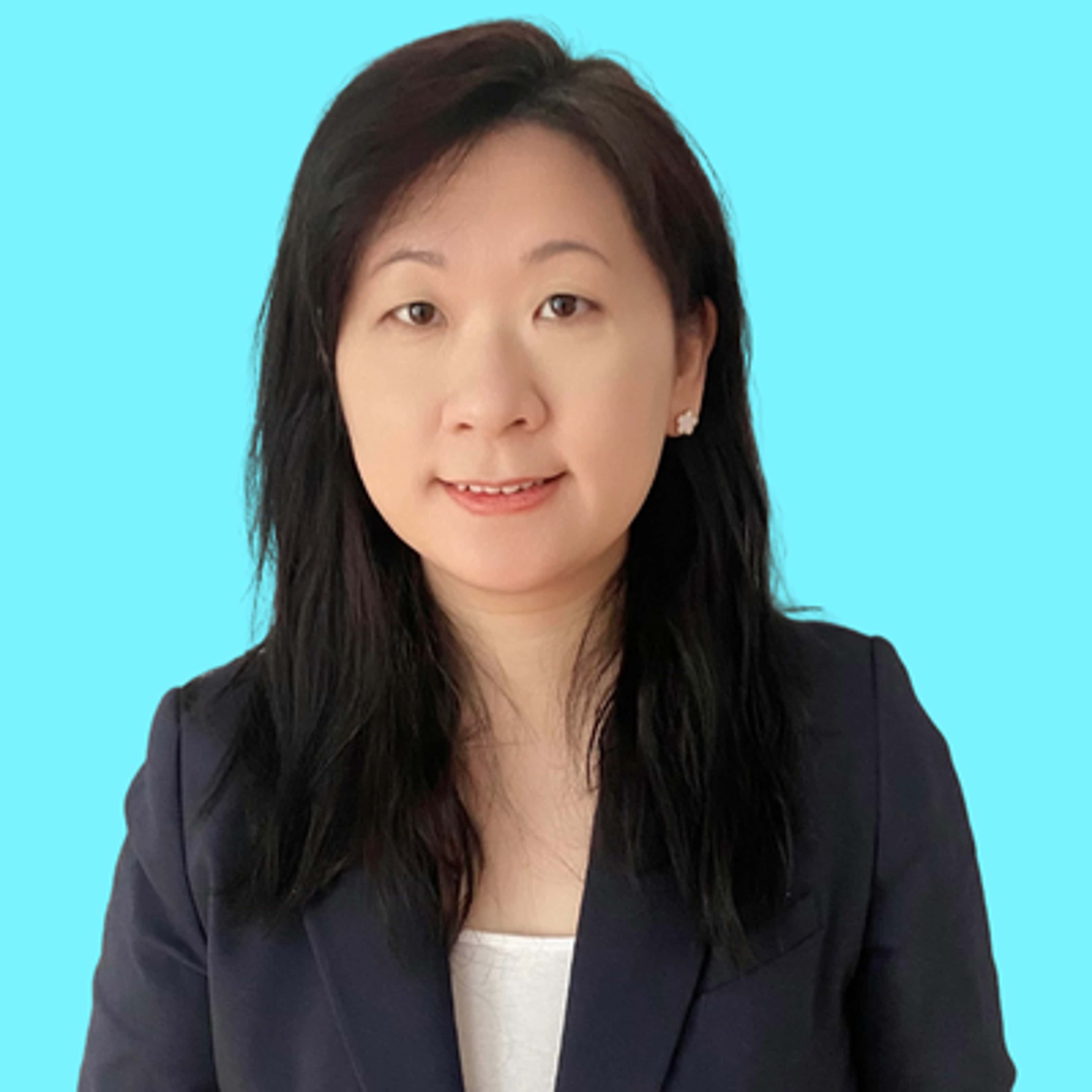 Anna Li in a tailored business suit, exuding professionalism and confidence in her stance.