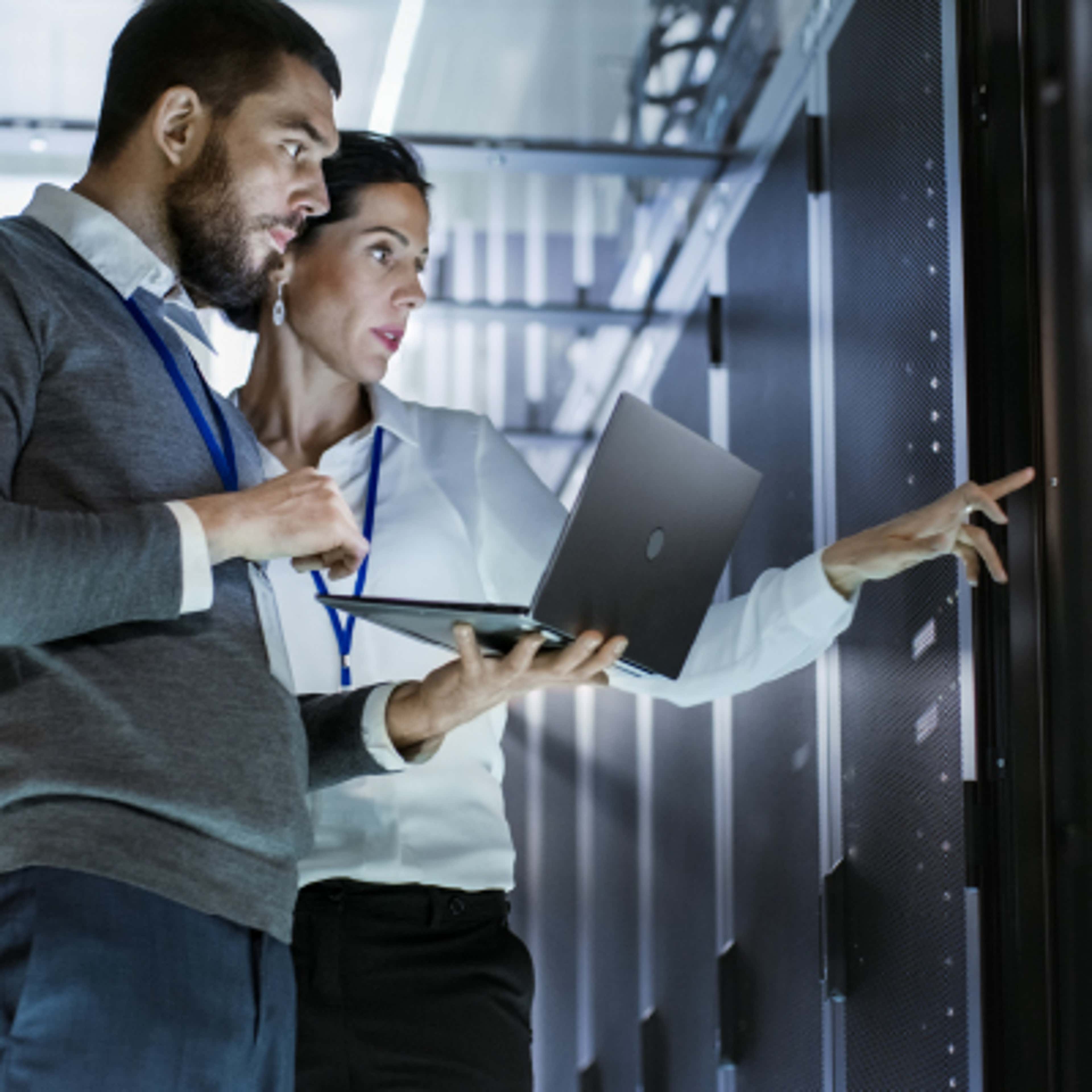 Two people inside a data center