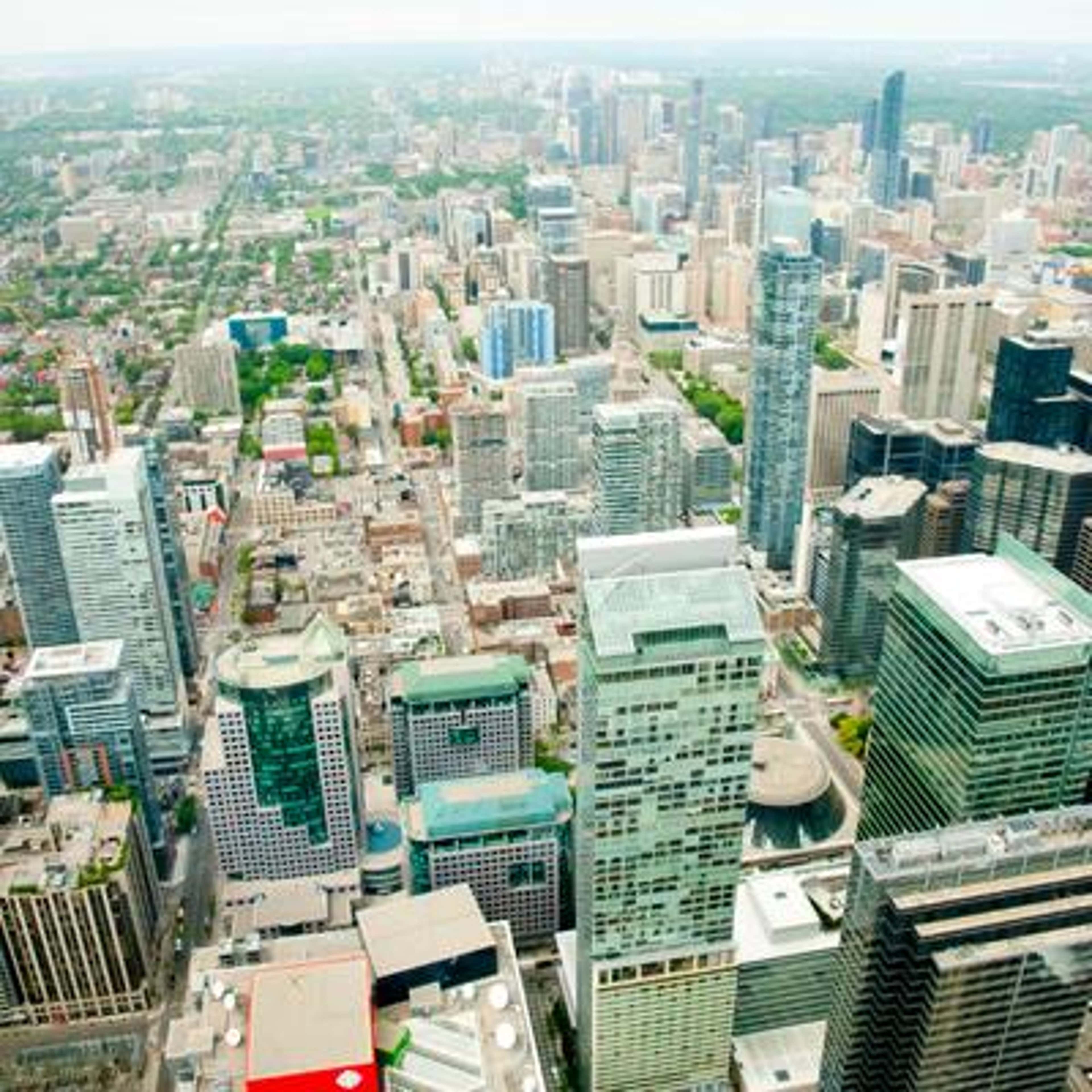 An aerial view of a dense city center featuring numerous skyscrapers and high-rise buildings