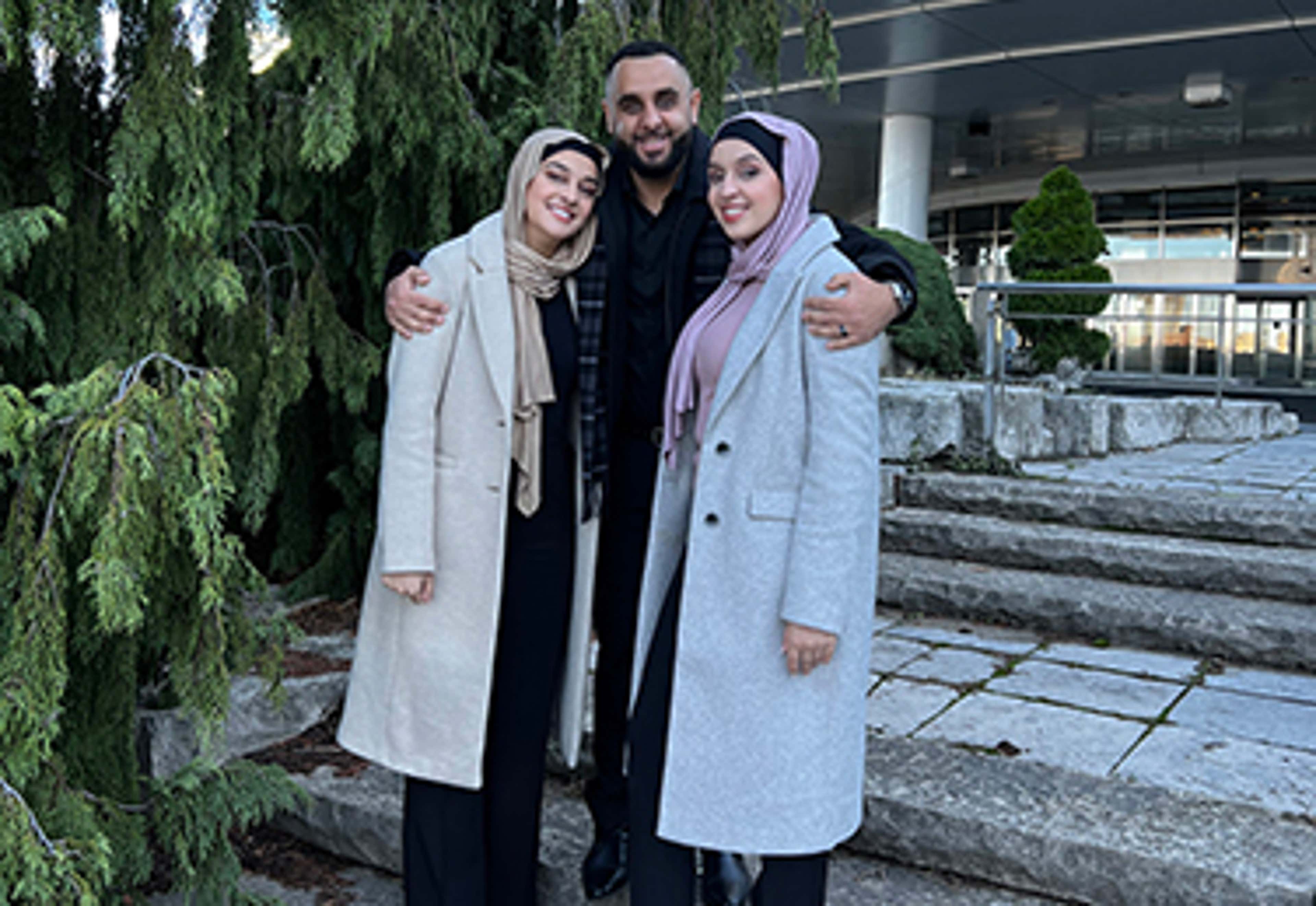 The three Hedjazi siblings standing together outside