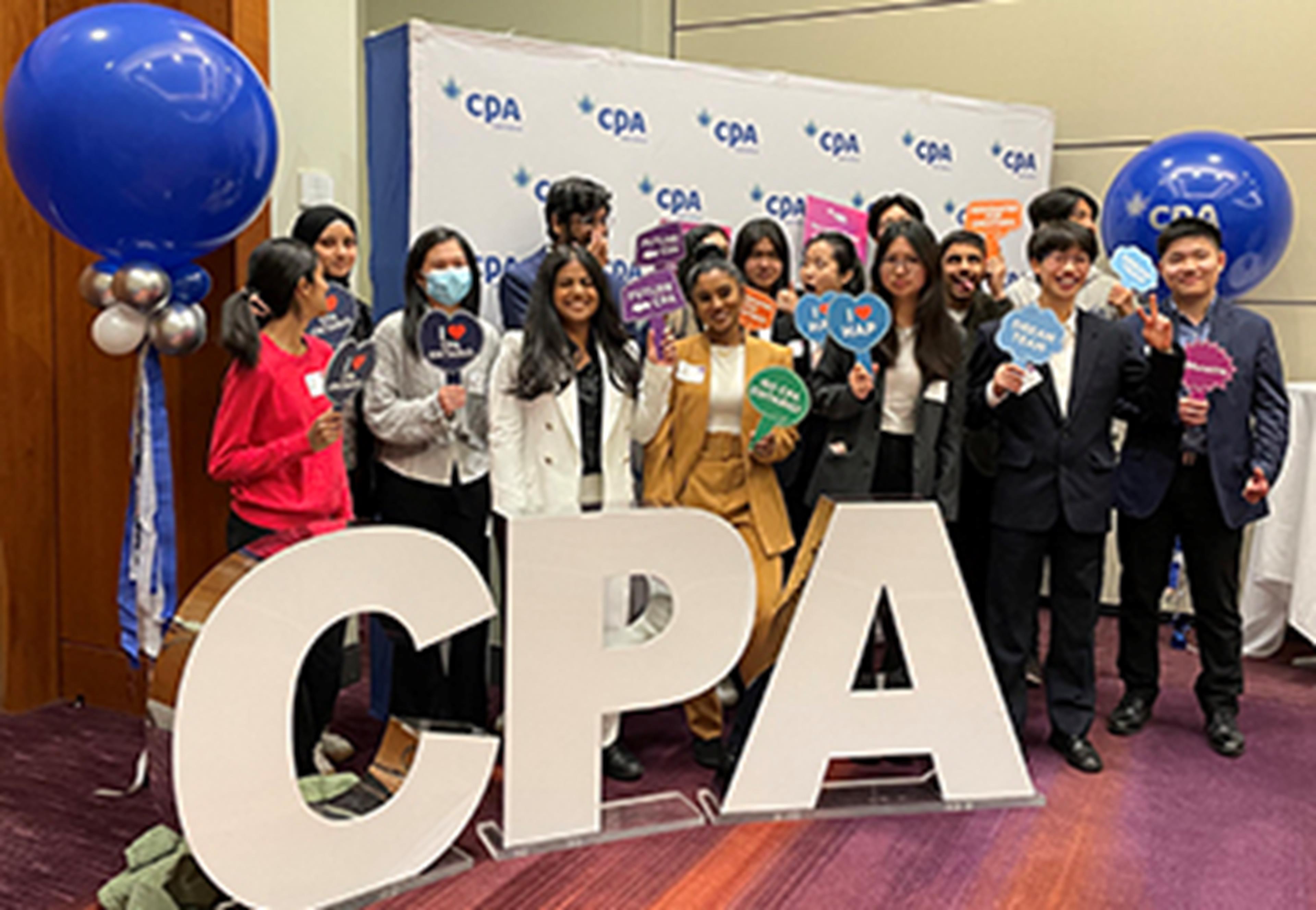 Group on students standing behind CPA sign
