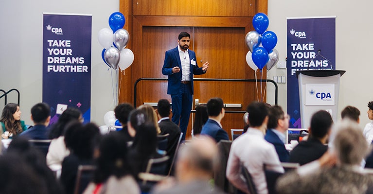 Speak on stage with CPA signs