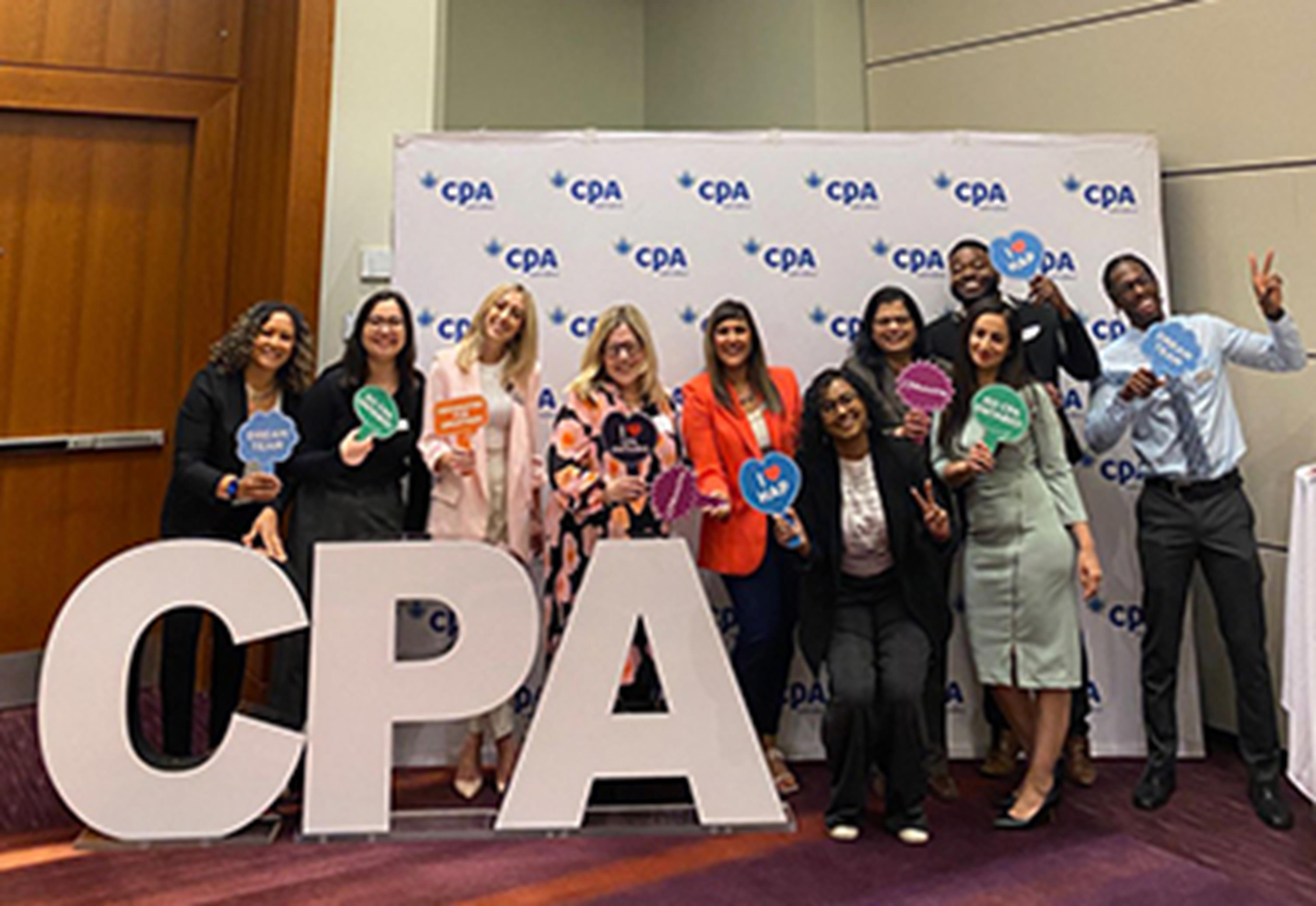 Group of recruiters around CPA sign