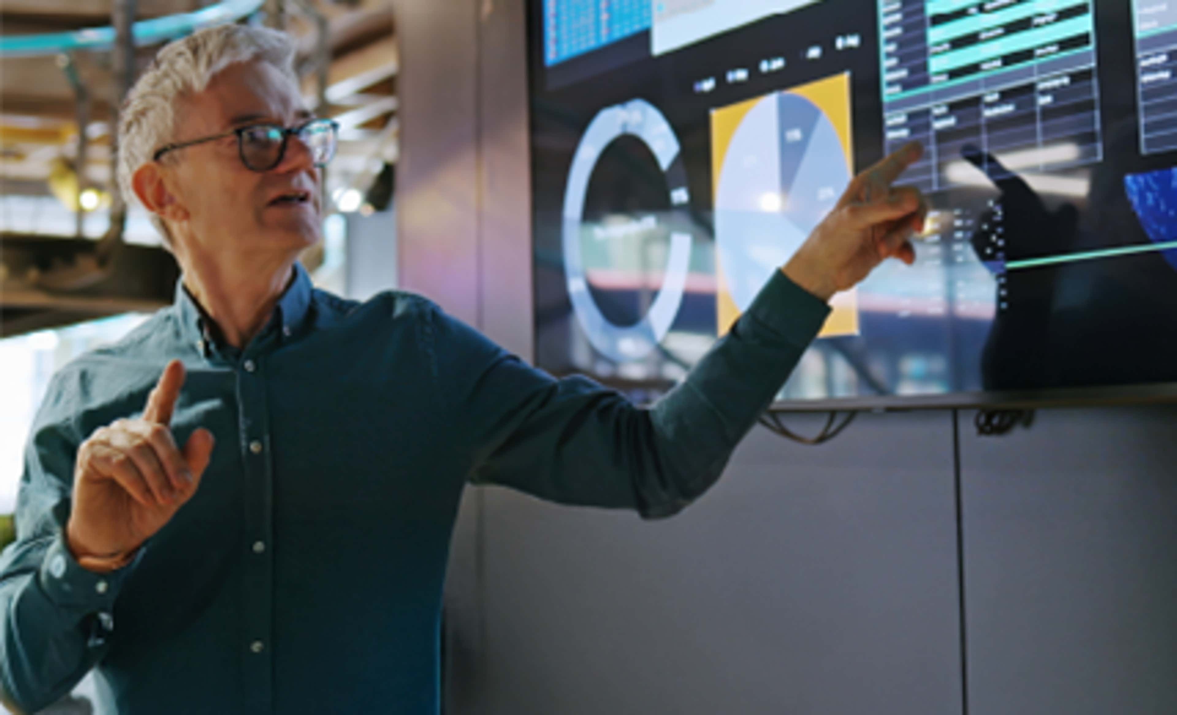 Man pointing at a screen