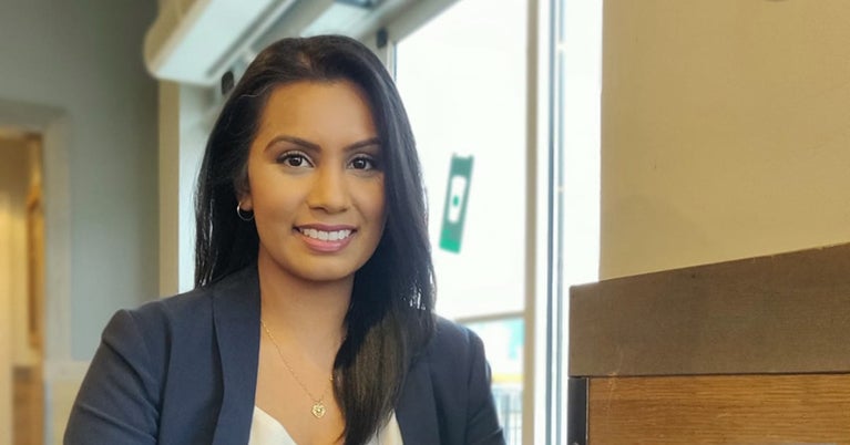 Tracy Singh sitting at table in coffee shop