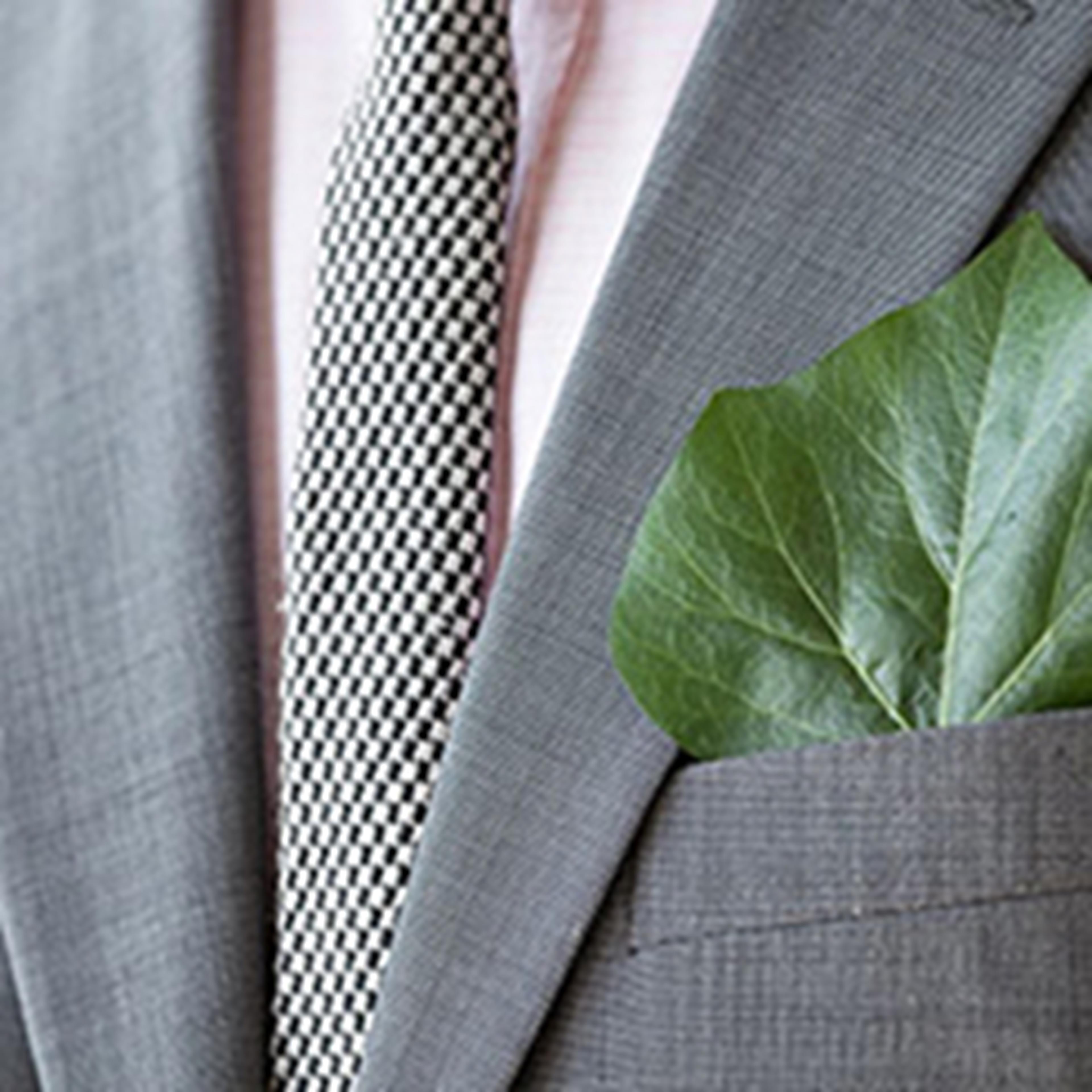 View of suit and tie with leaf in pocket