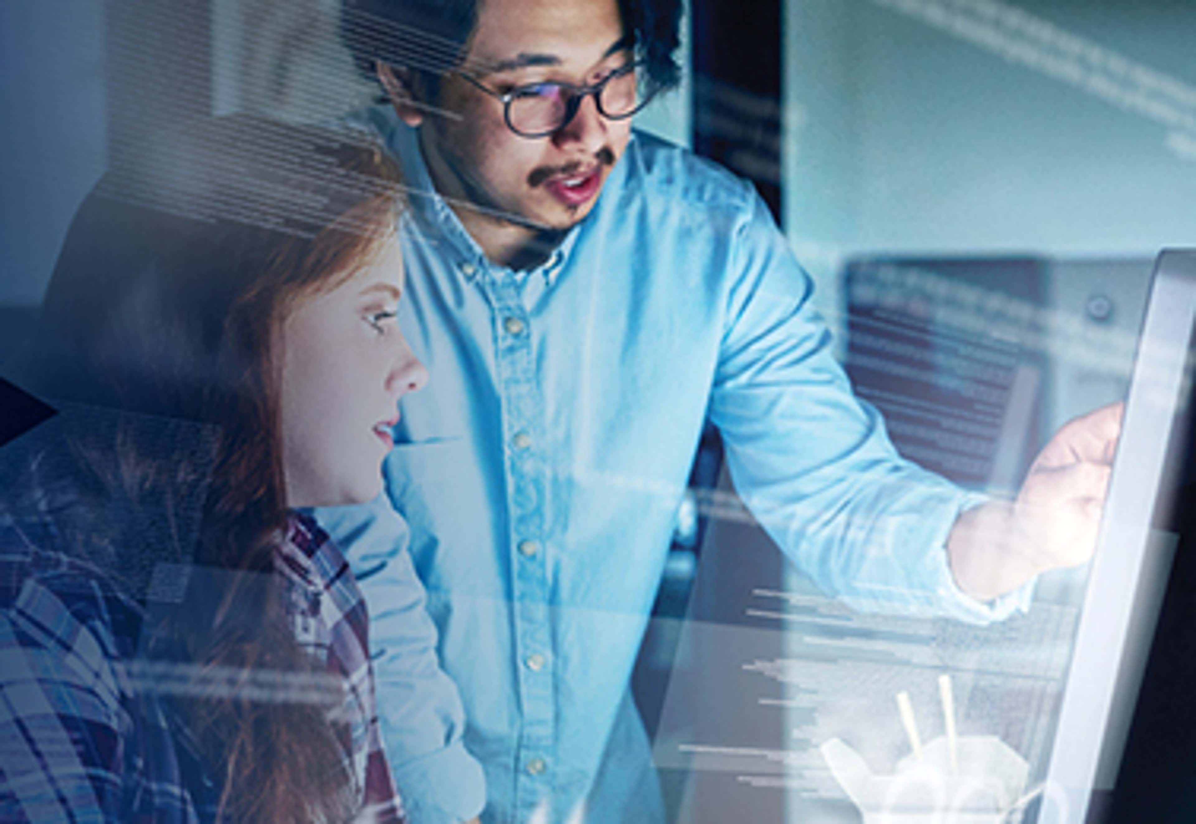 Two people looking at a screen