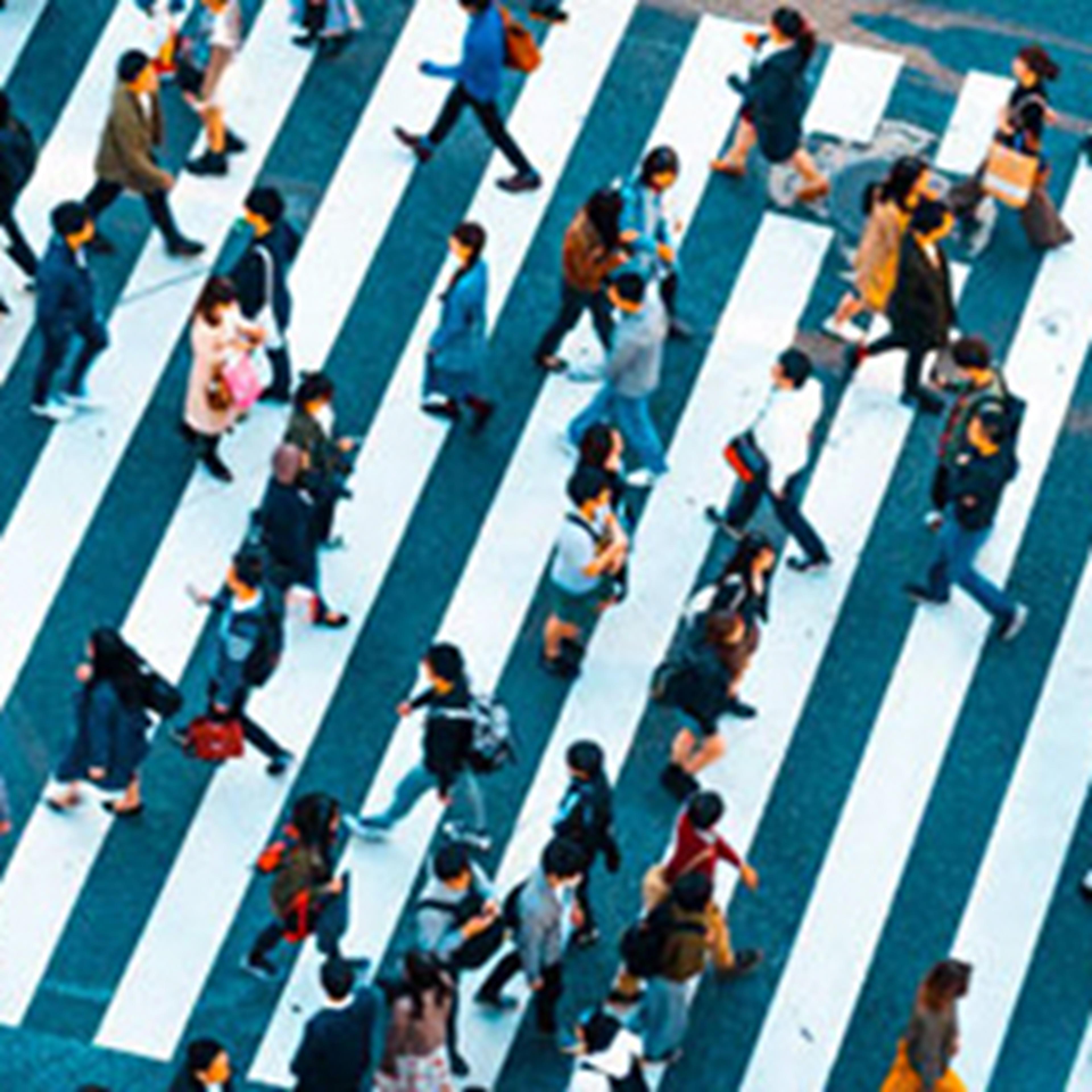 Overhead view of people walking across a crosswalk