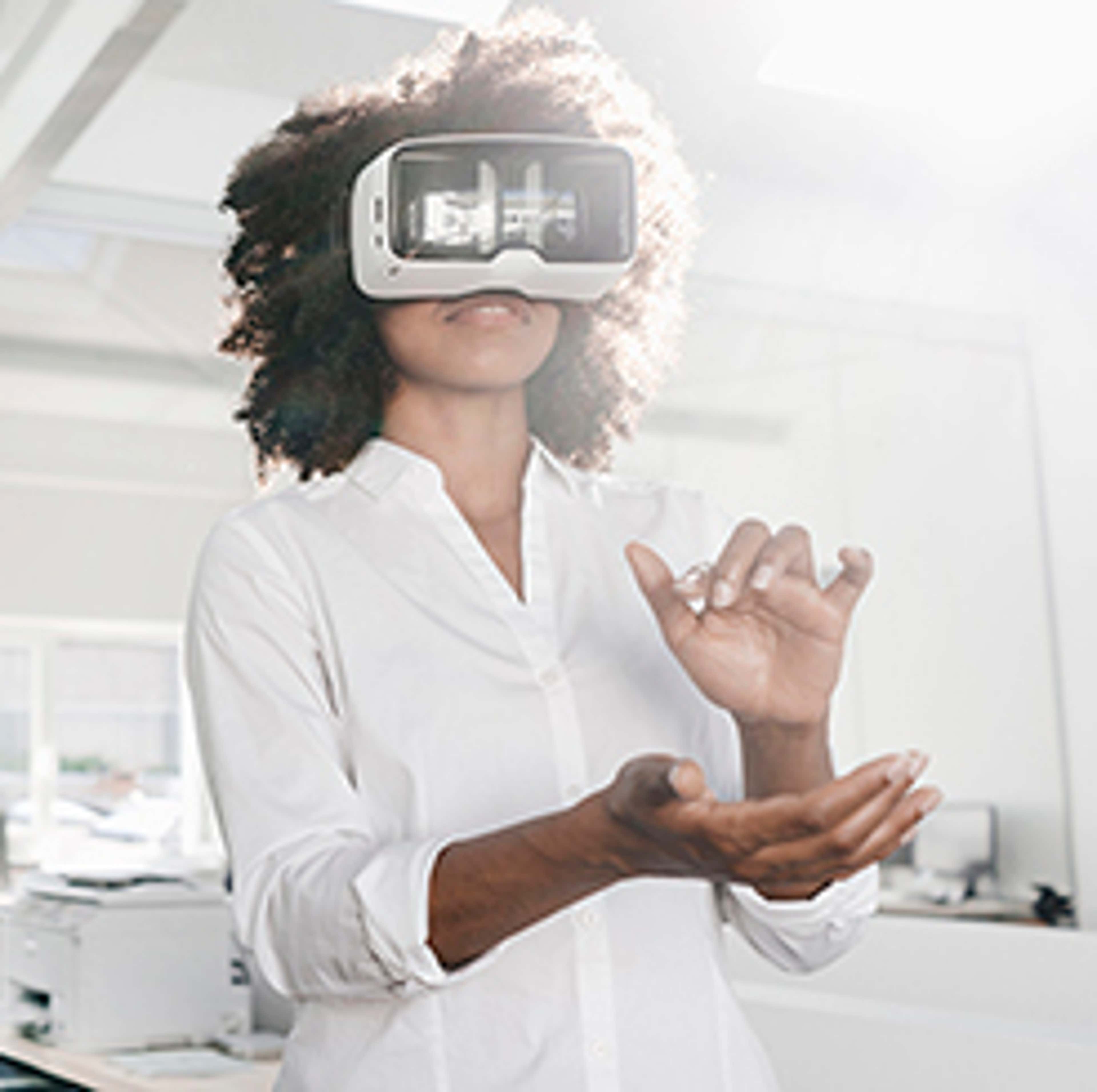 Women with VR helmet over eye making movement with hands