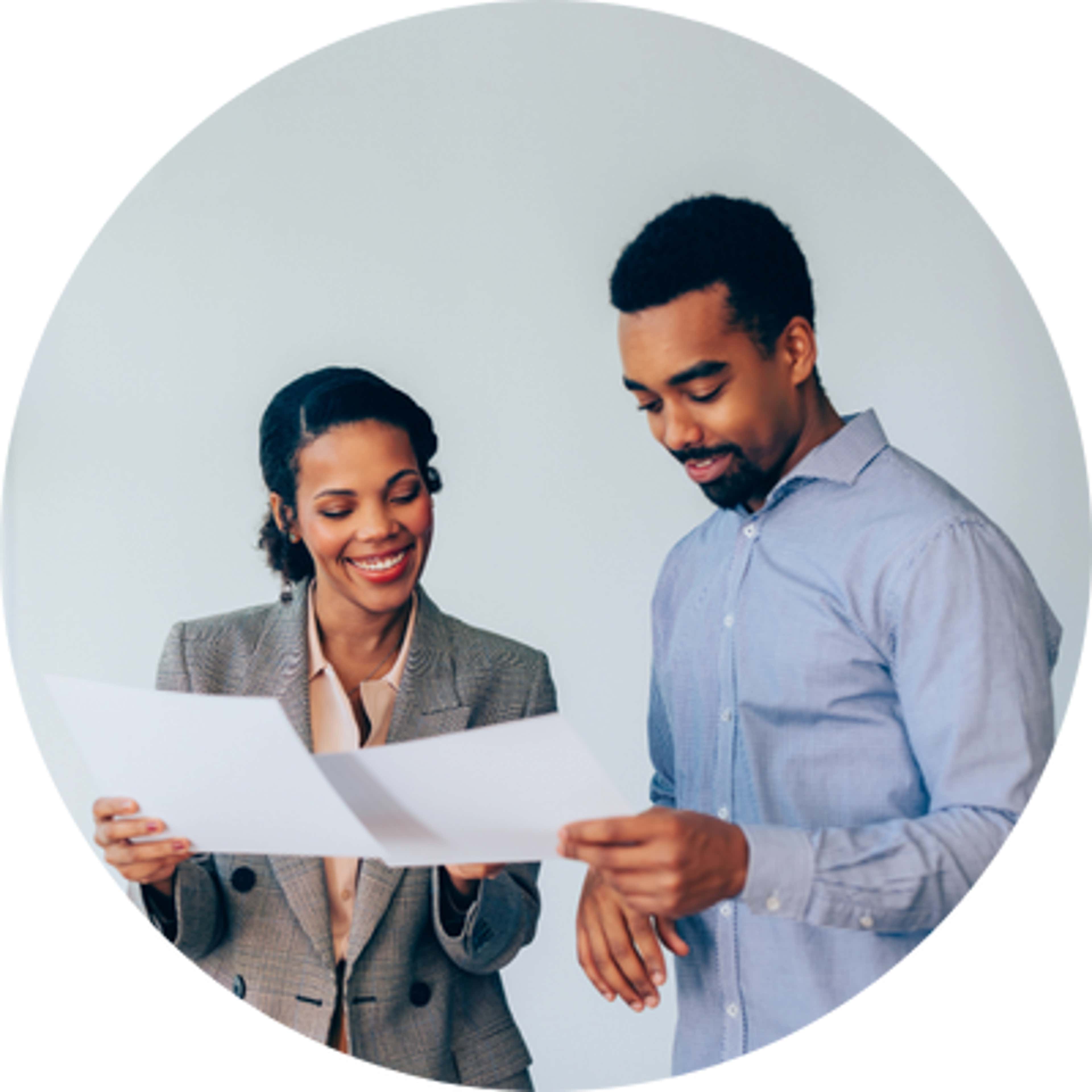 a man and a woman holding white papers in their hands and discussing