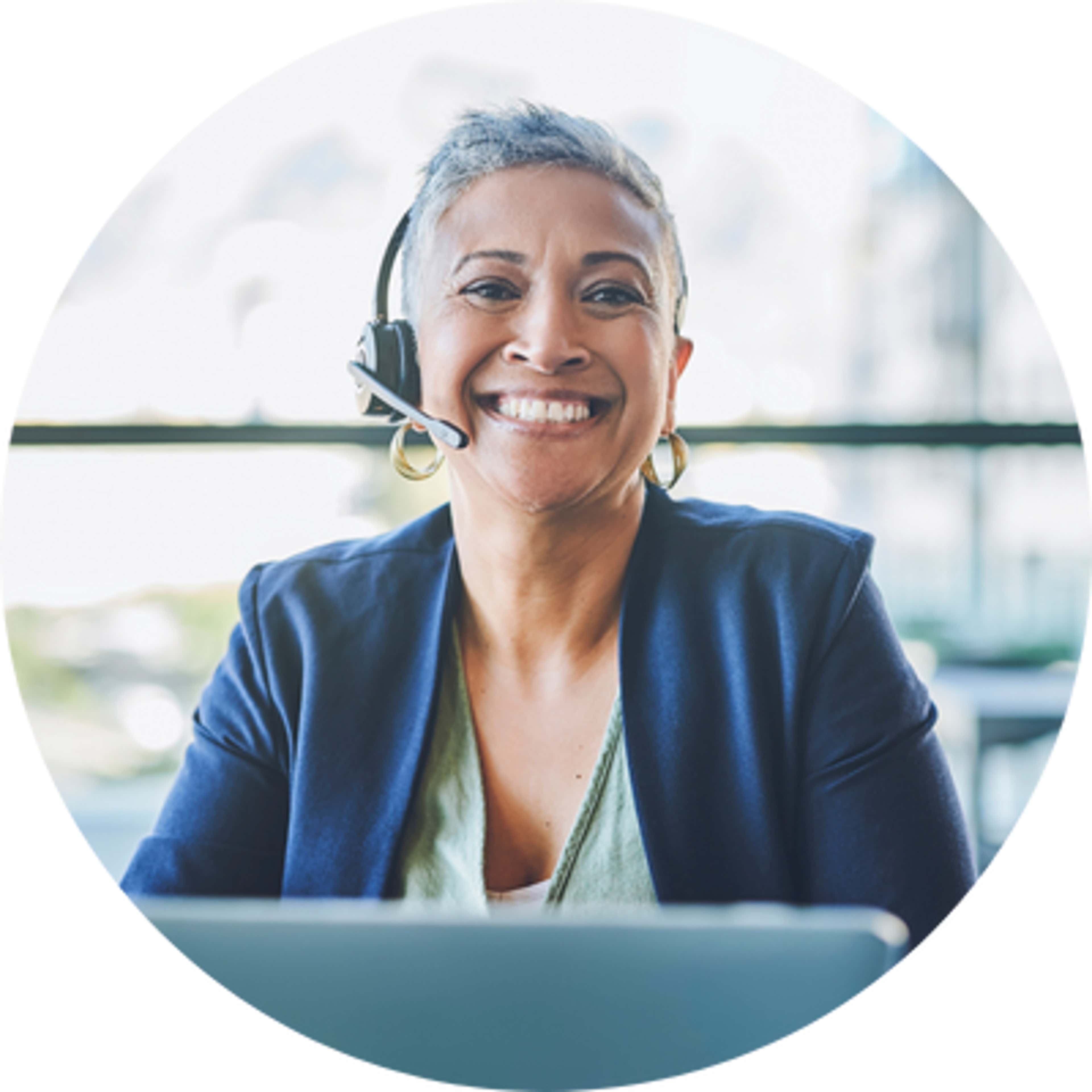 a women wearing headphone & smiling