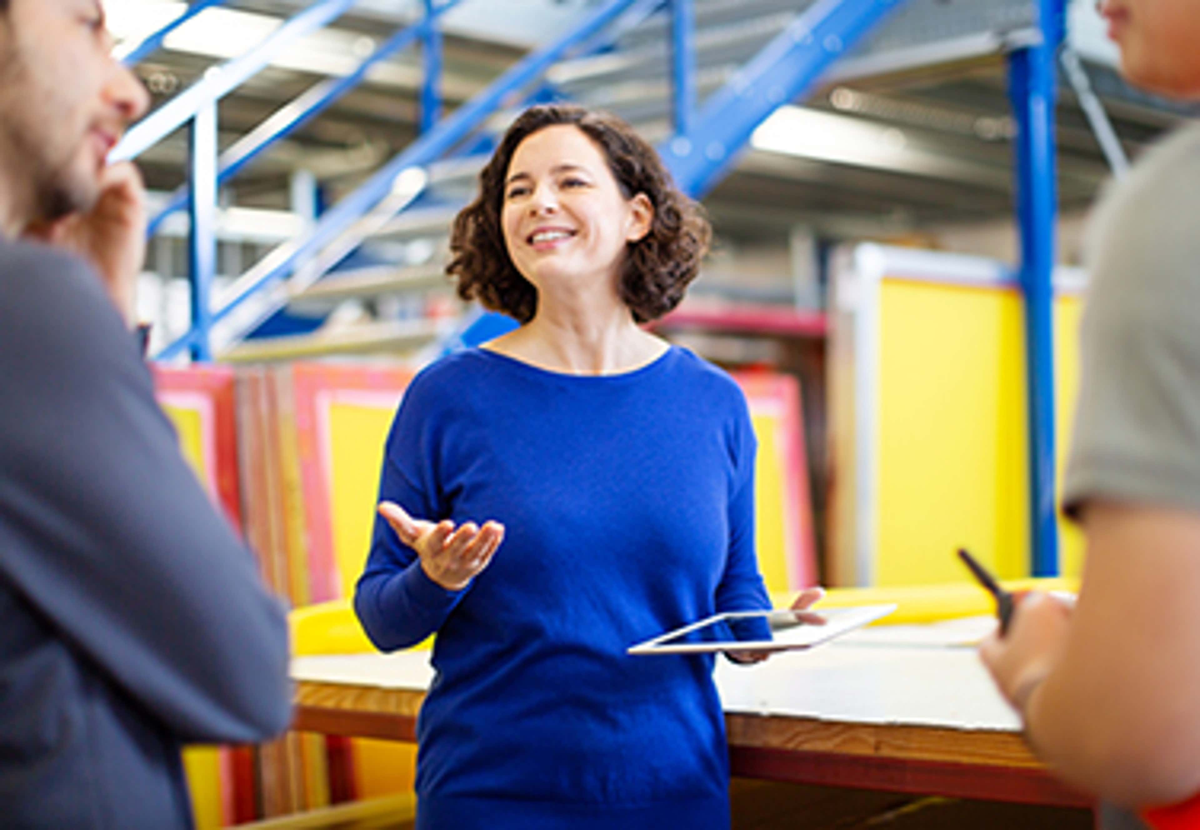Business woman talking to employees