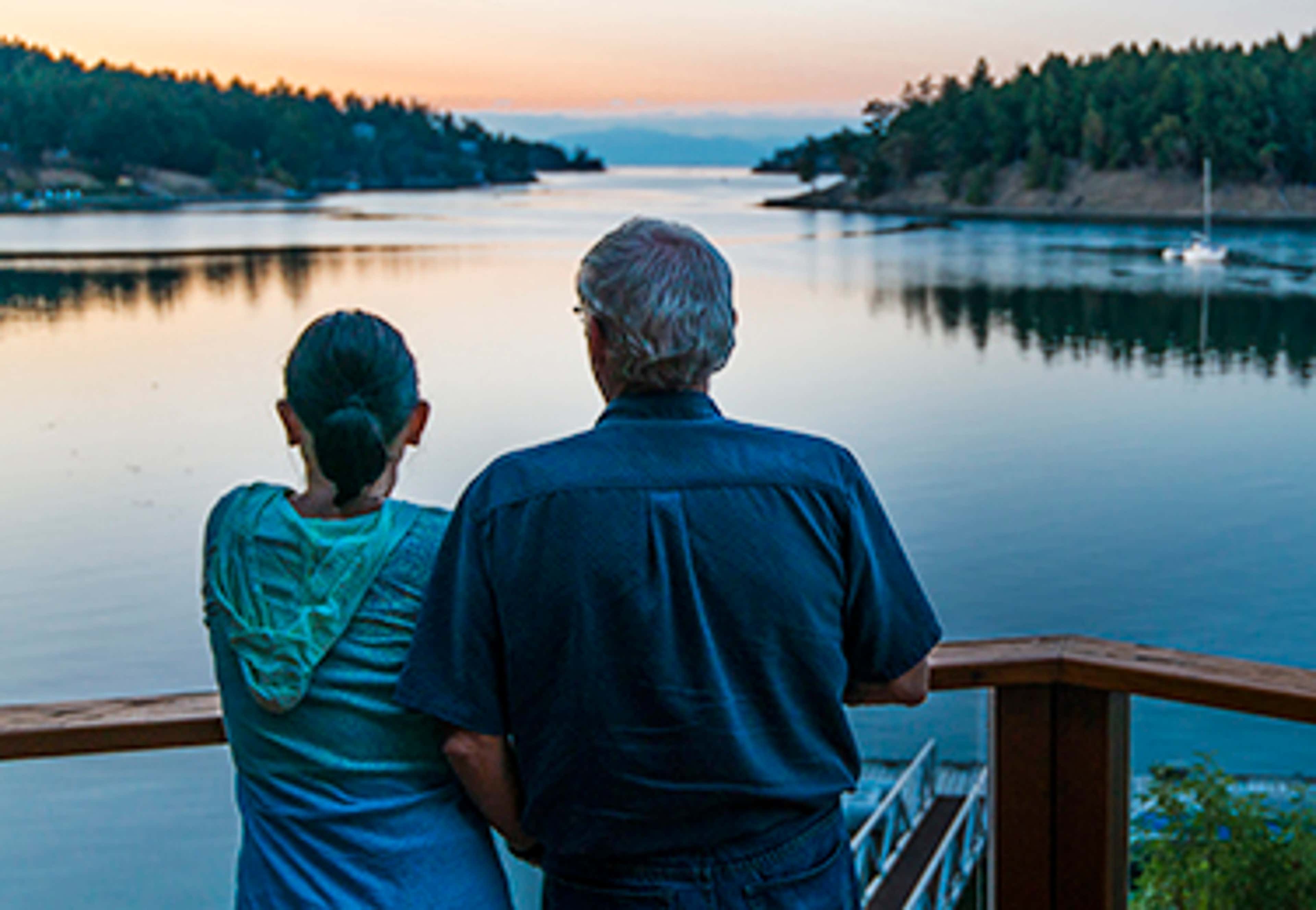 two people looking at a lake