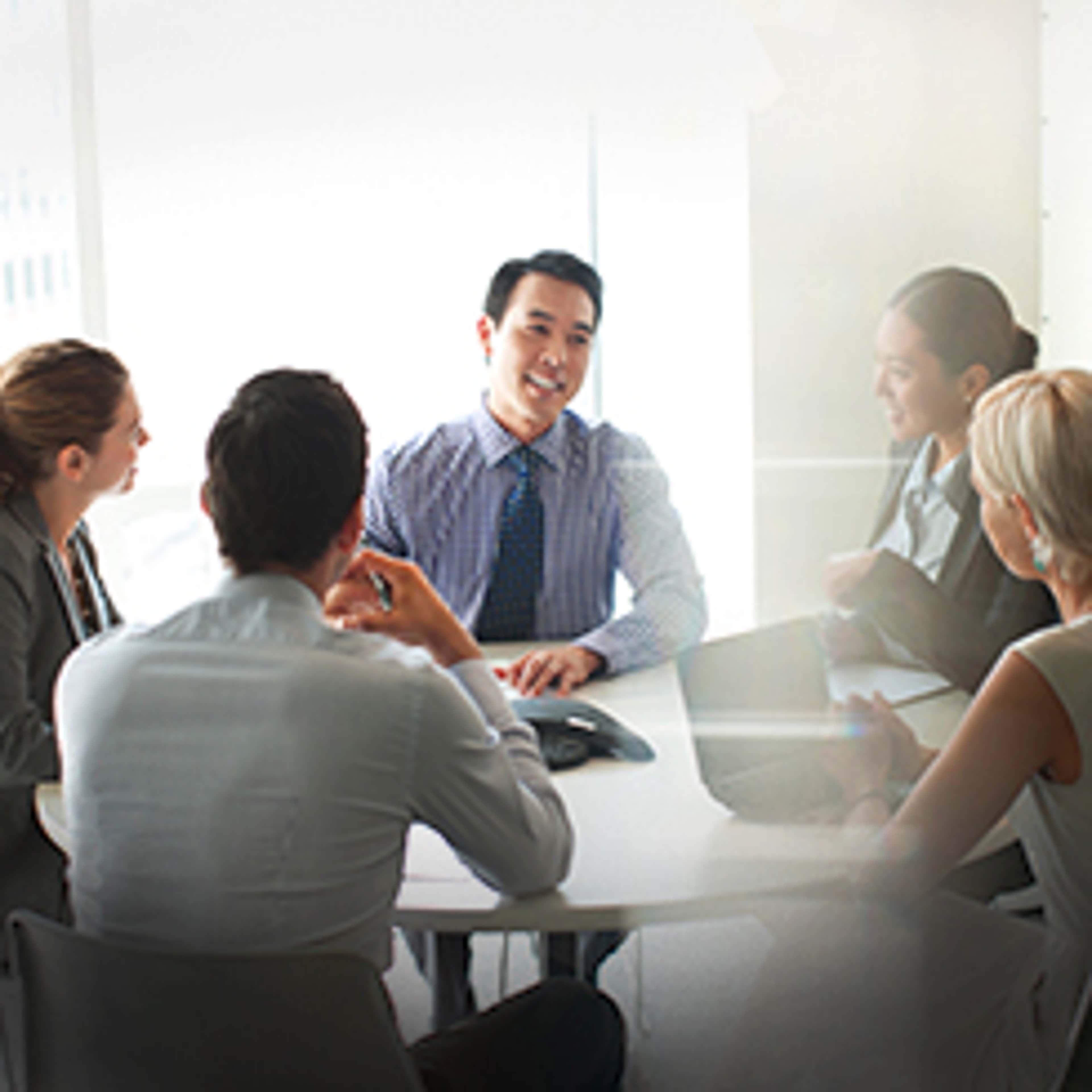 People in office talking around table