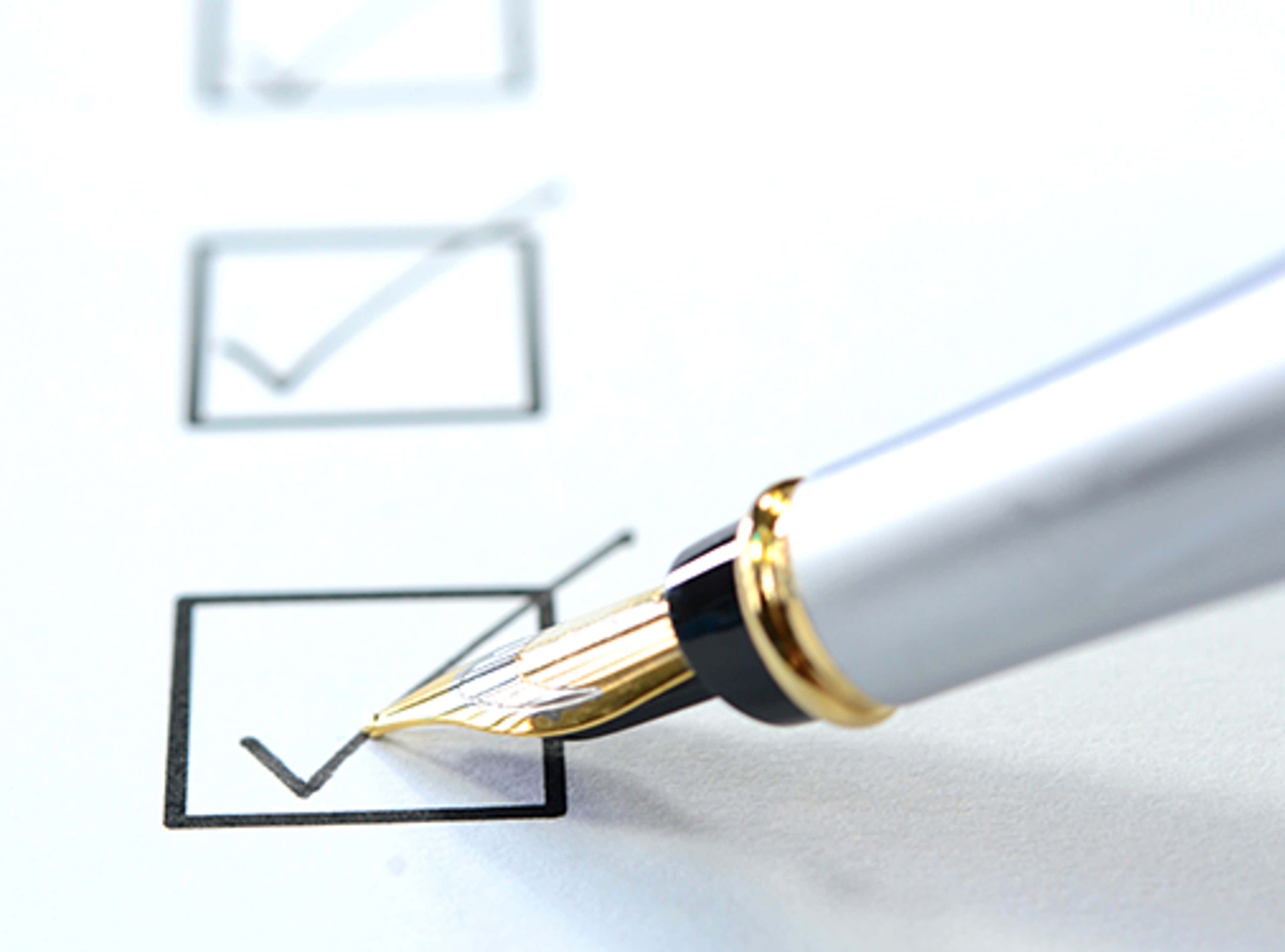 Pen writing a checkmark