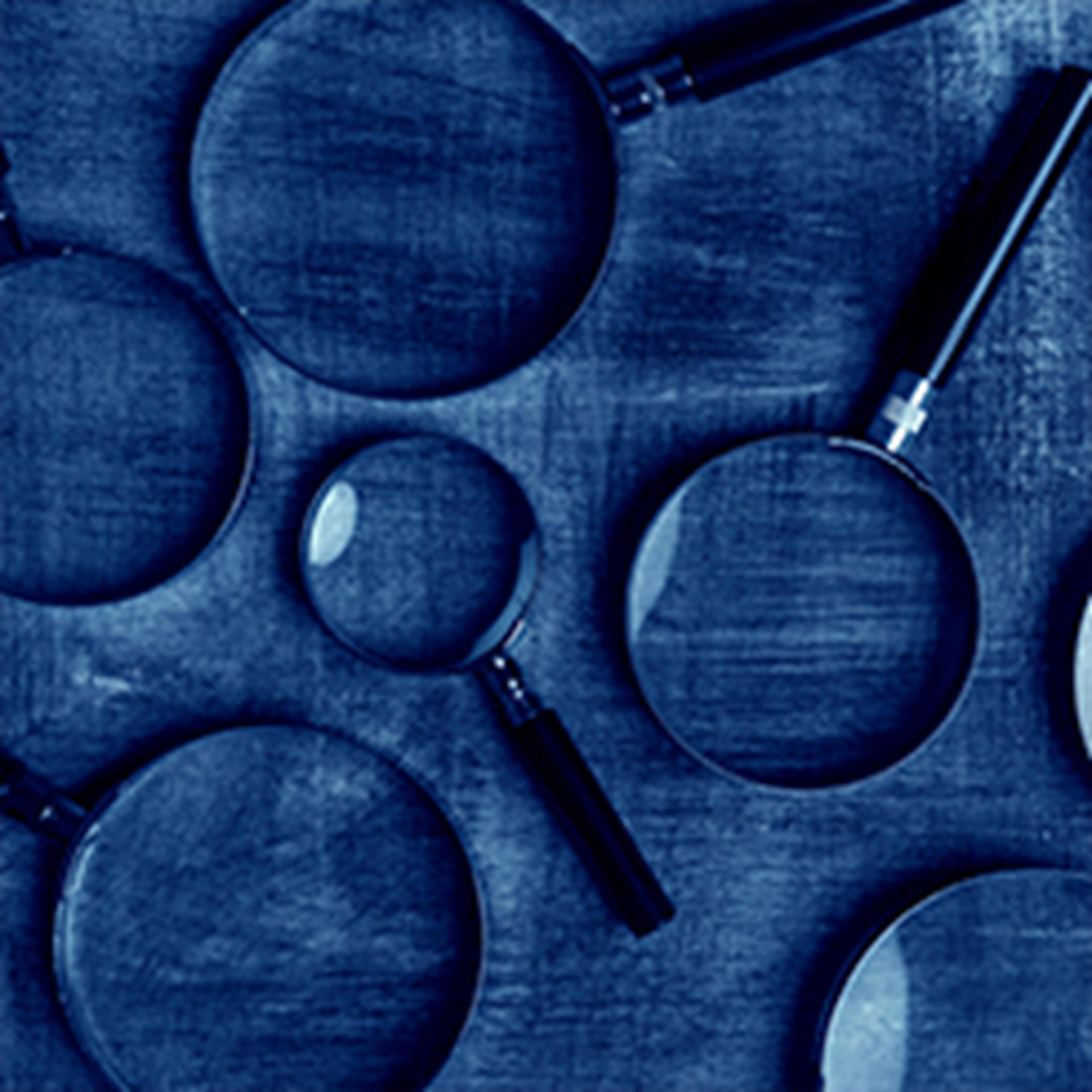 Magnifying glasses on blue background