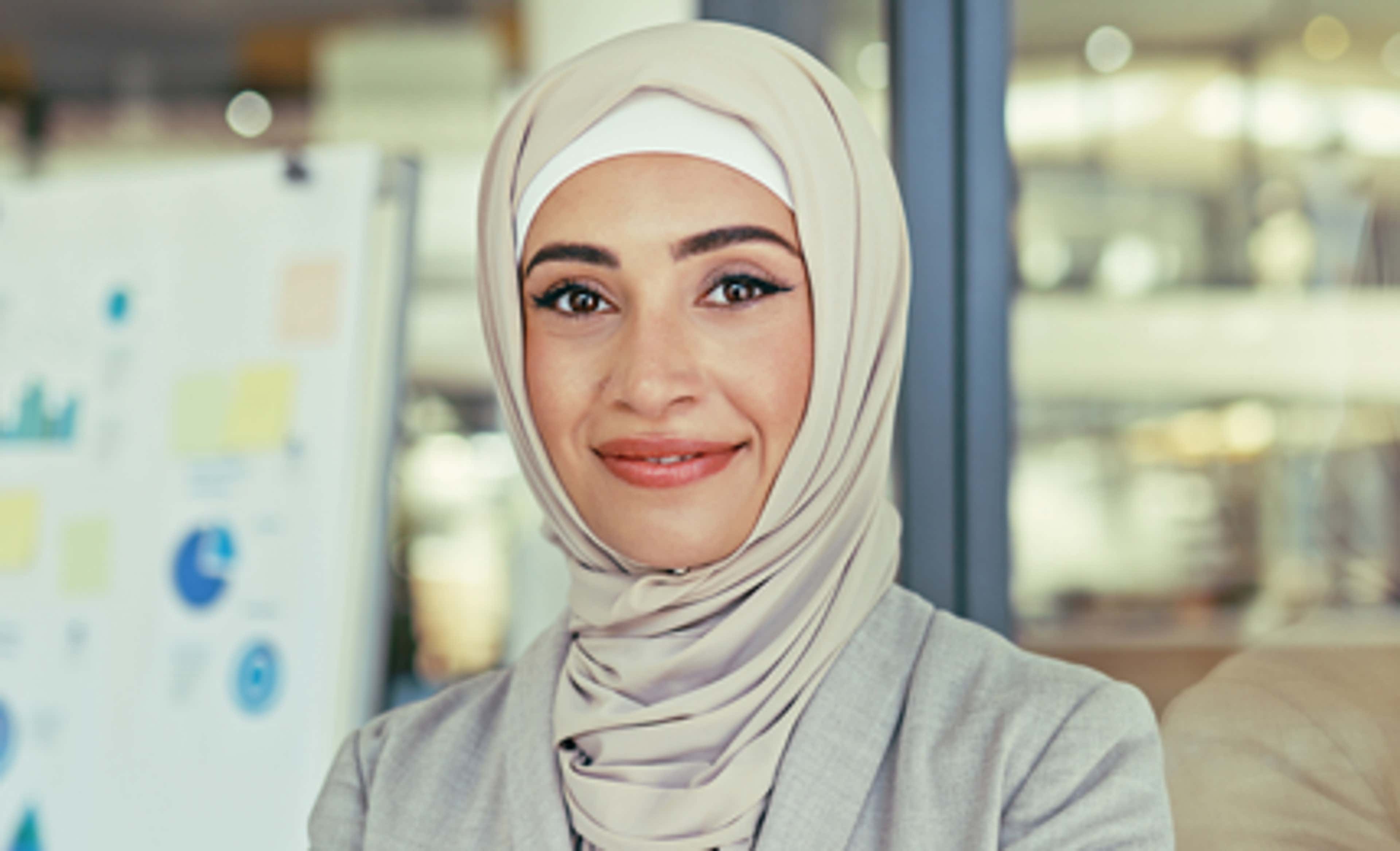 A woman wearing hijab and smiling