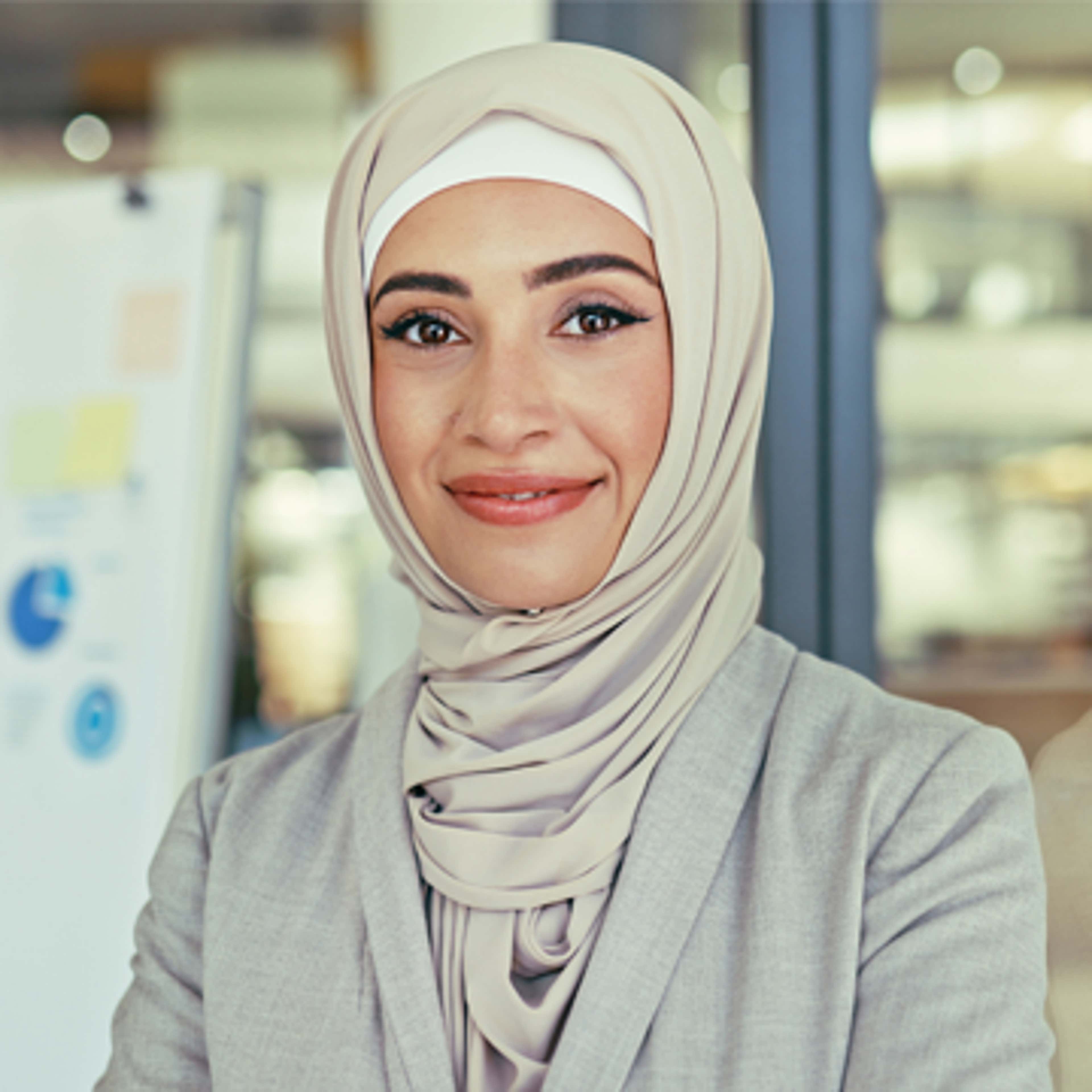 A woman wearing hijab and smiling