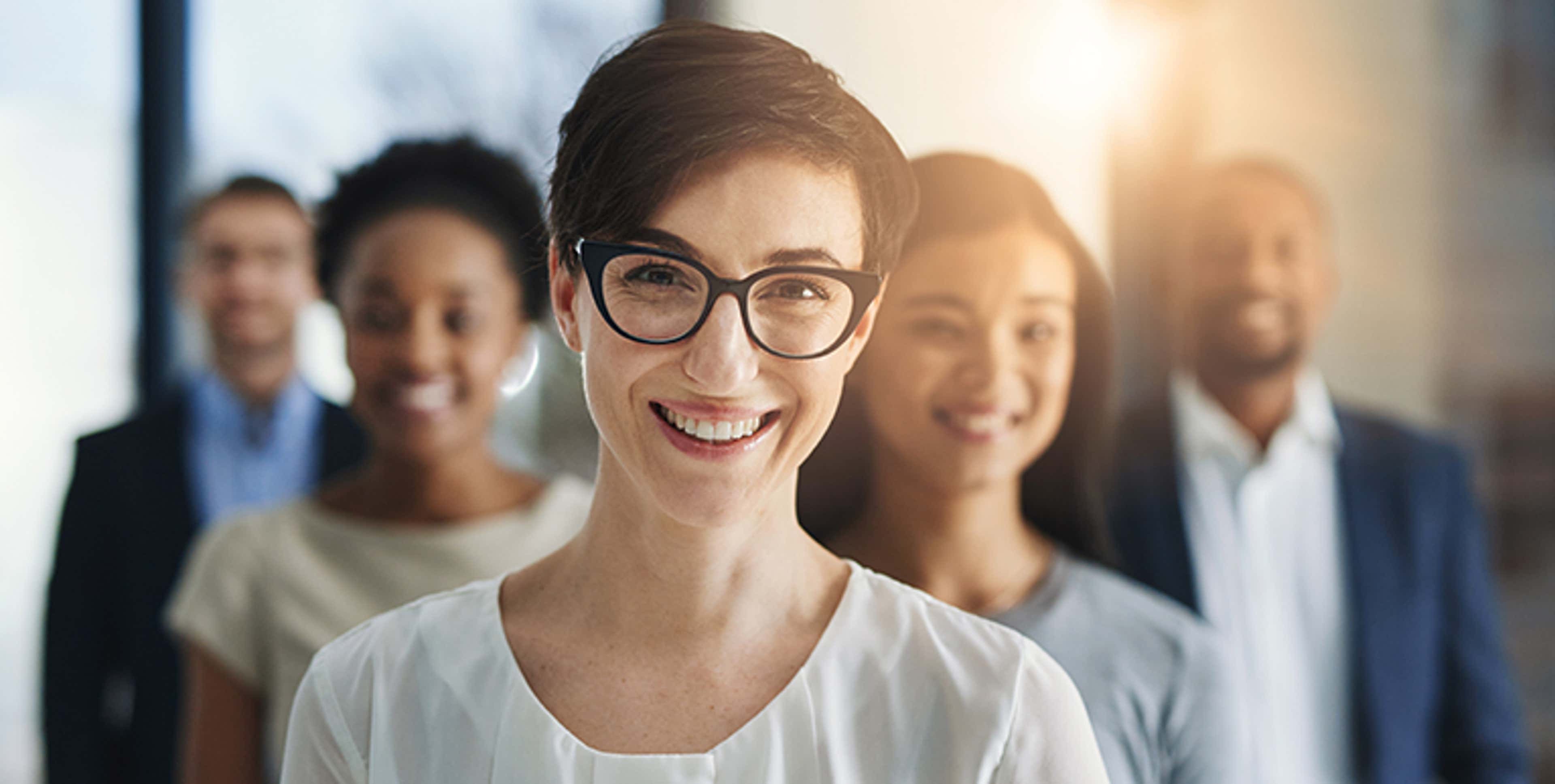 Five people looking at camera and smiling