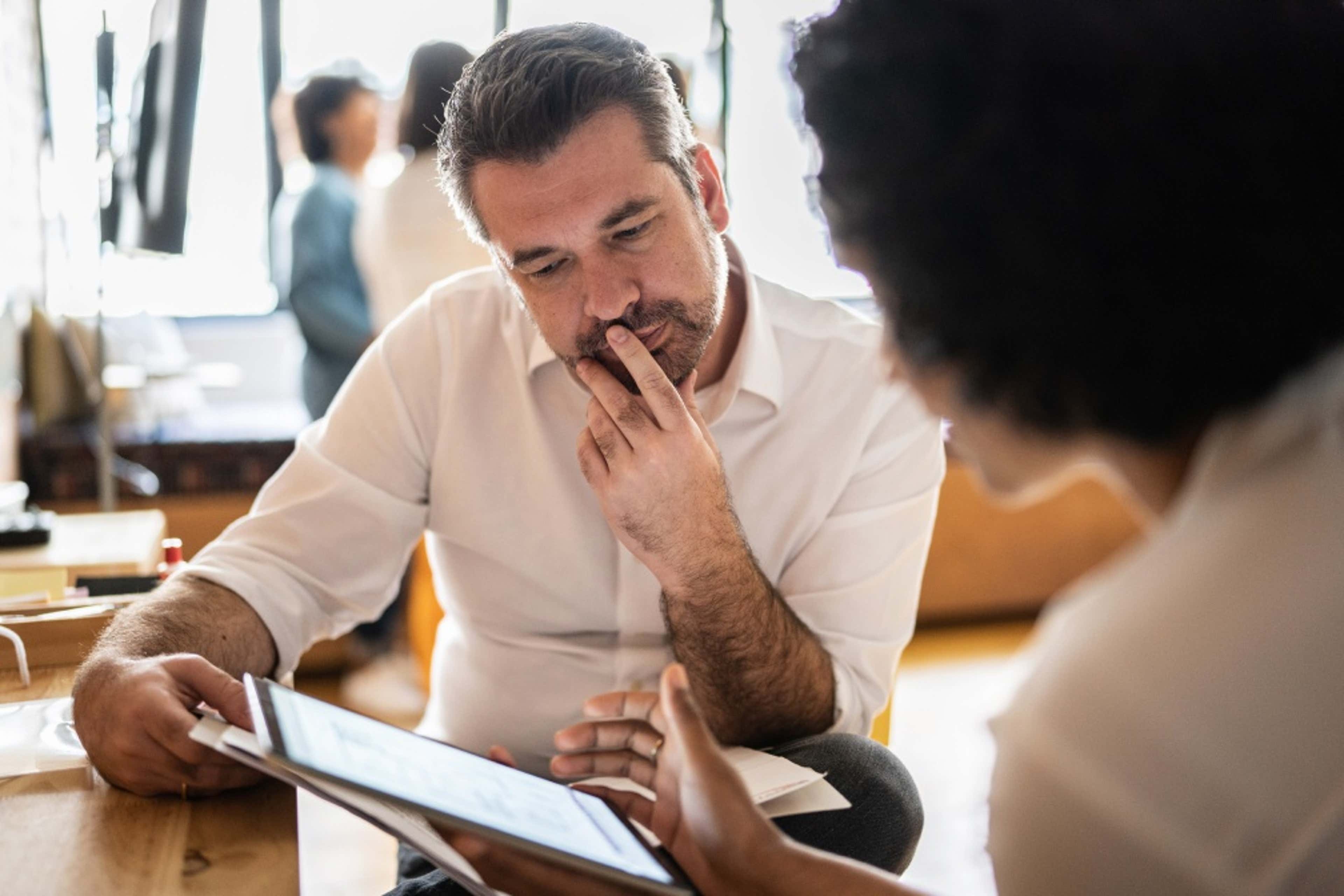man looking at a document with a woman