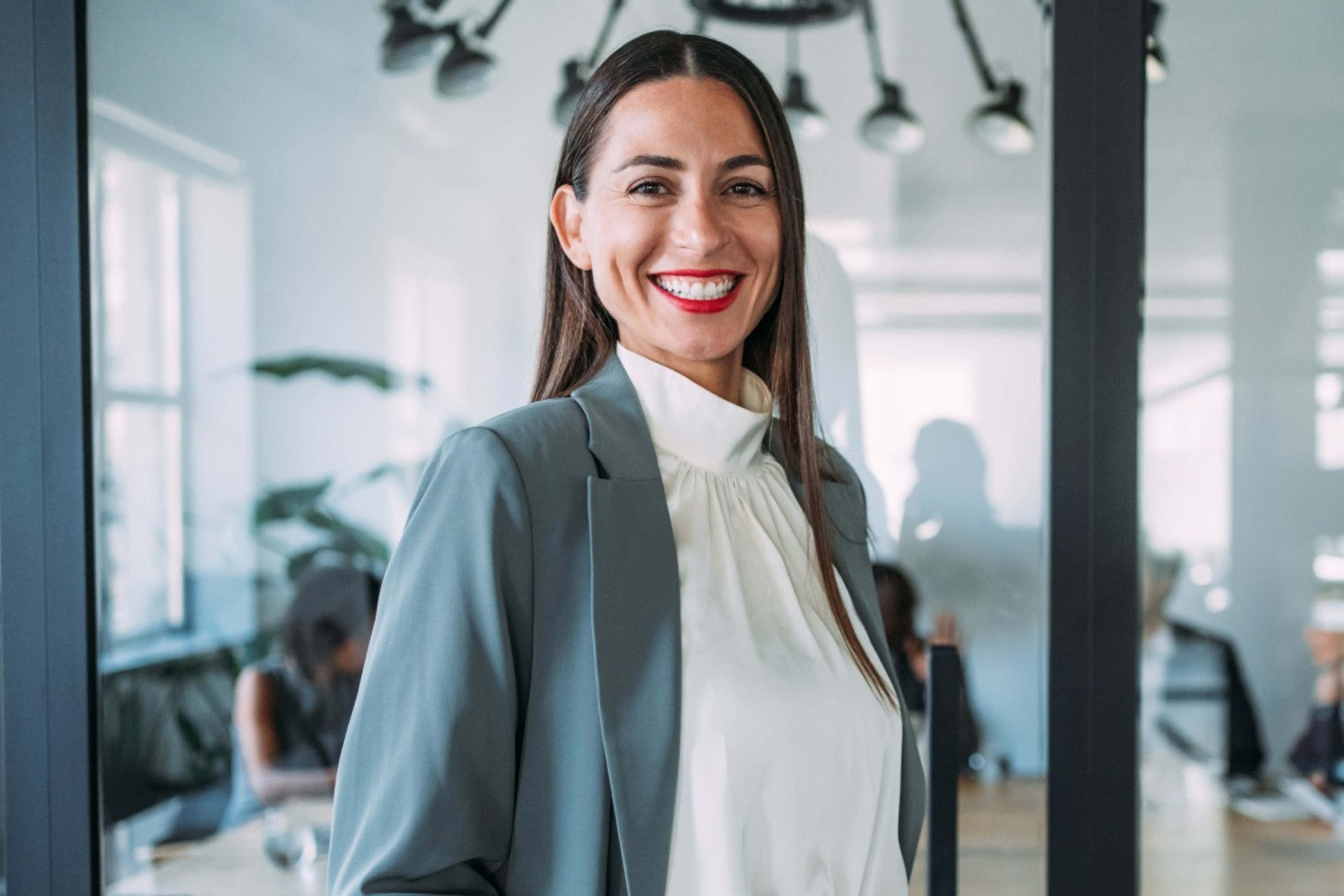 Smiling woman standing in front of meeting room