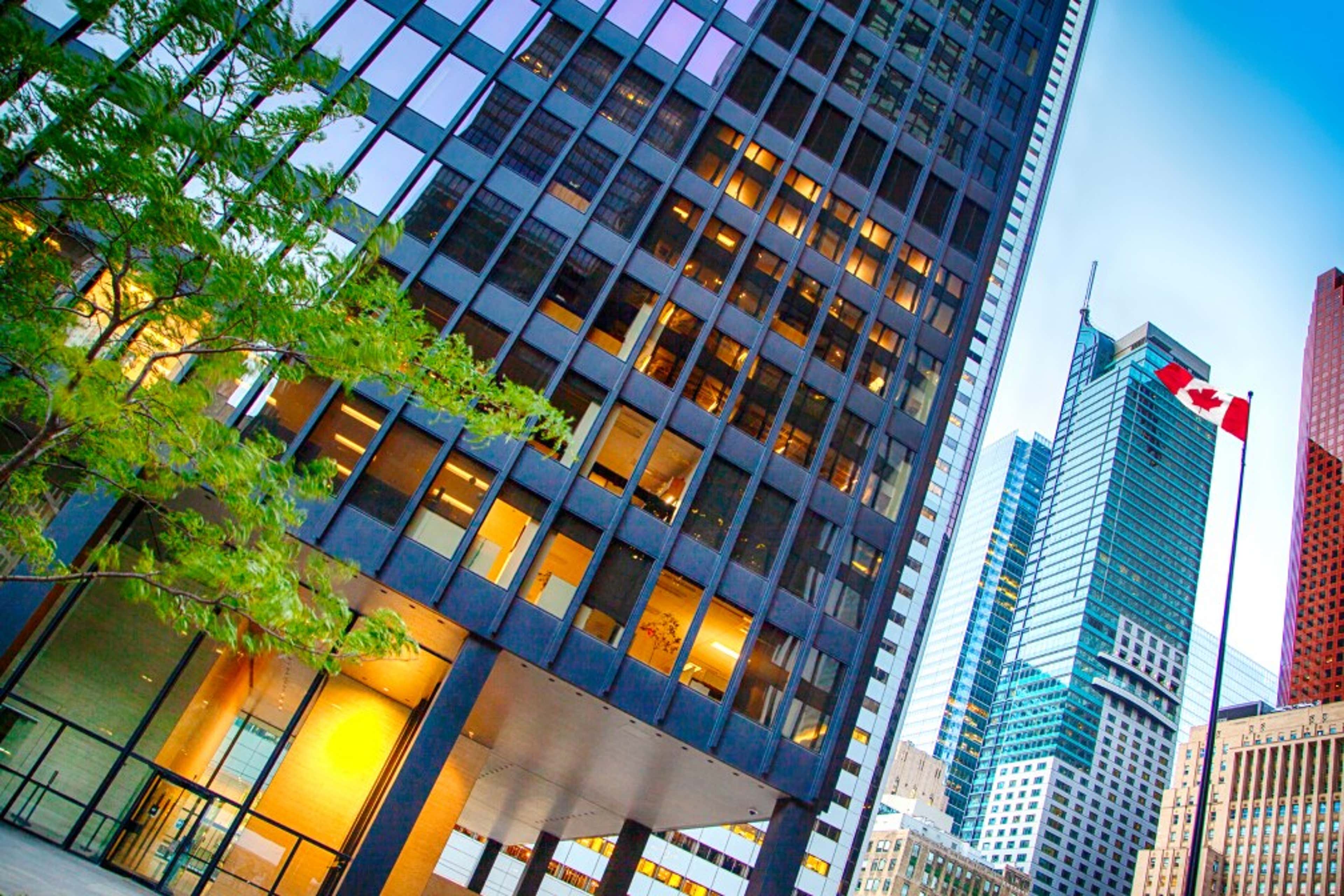 office buildings next to a canadian flag