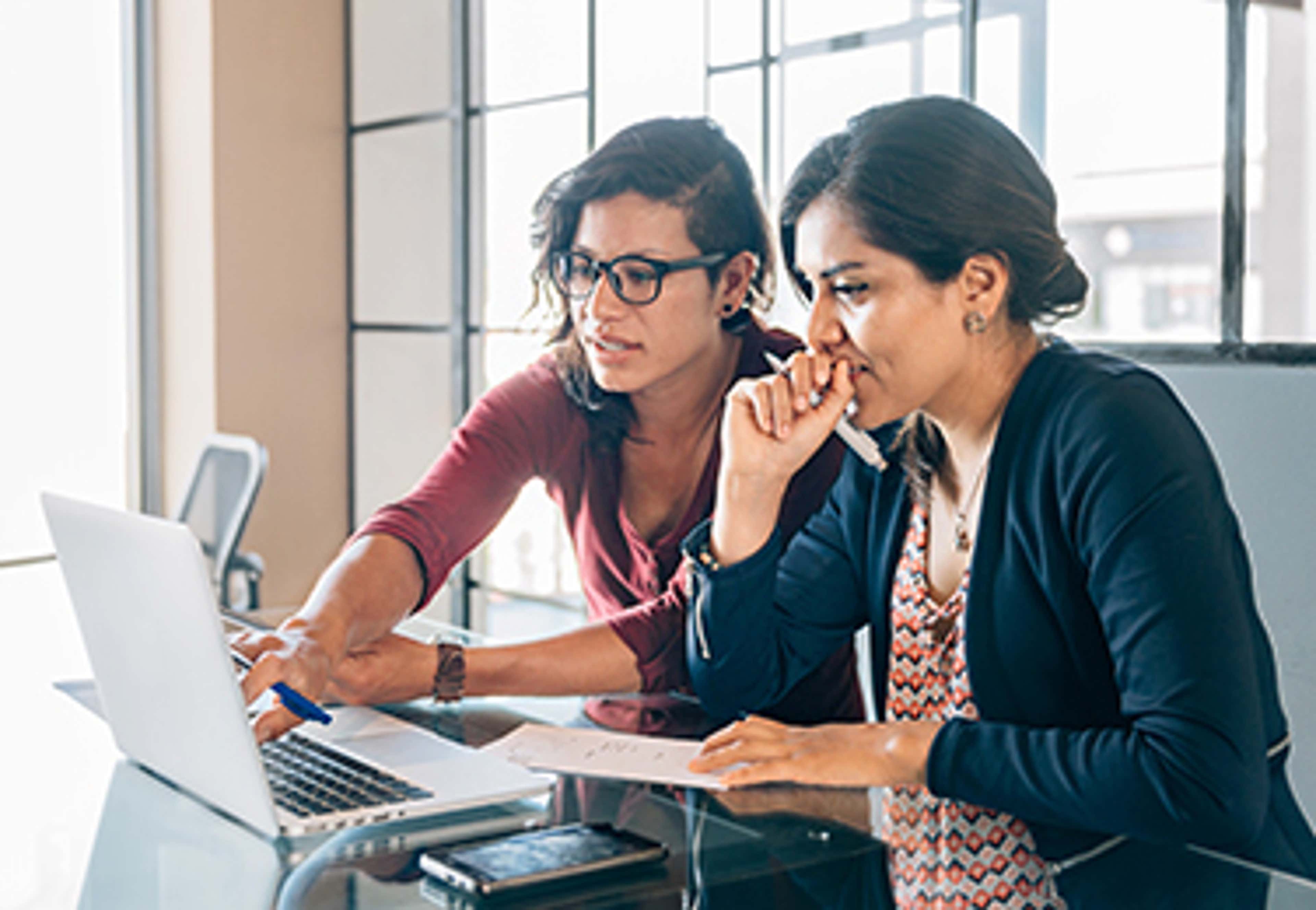 Two women working on a laptop