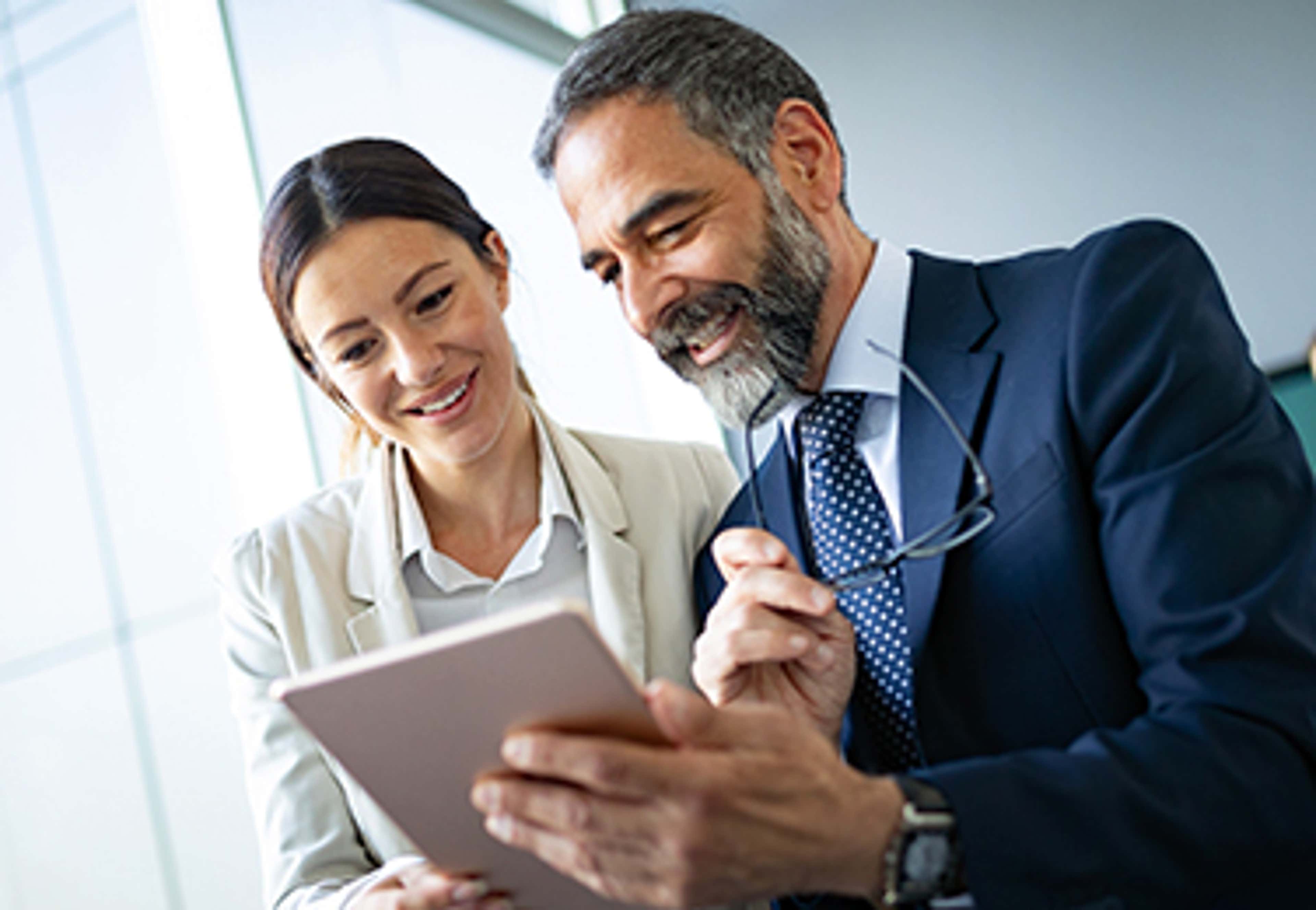 Man and woman talking while looking at a document