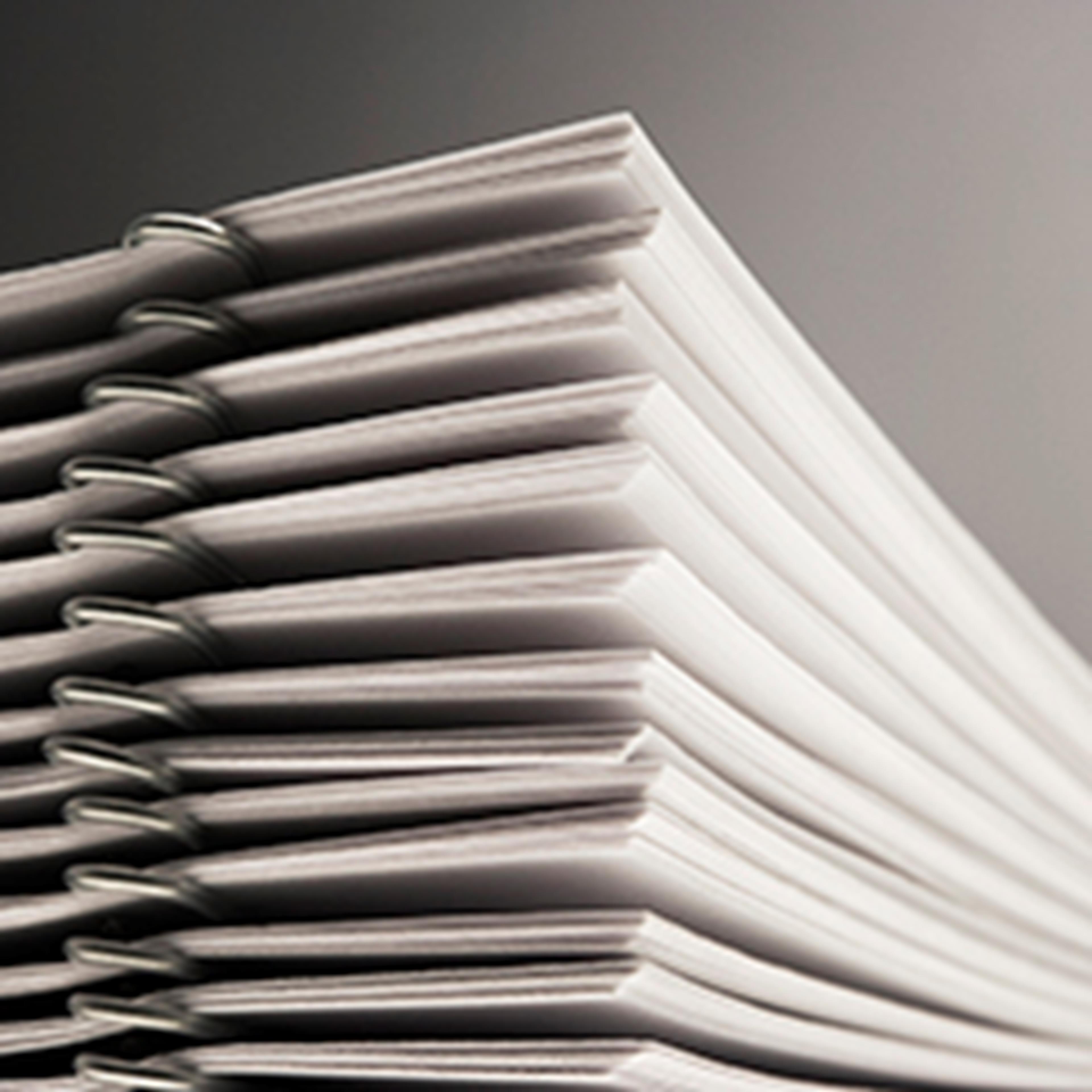 Stack of documents against a grey background