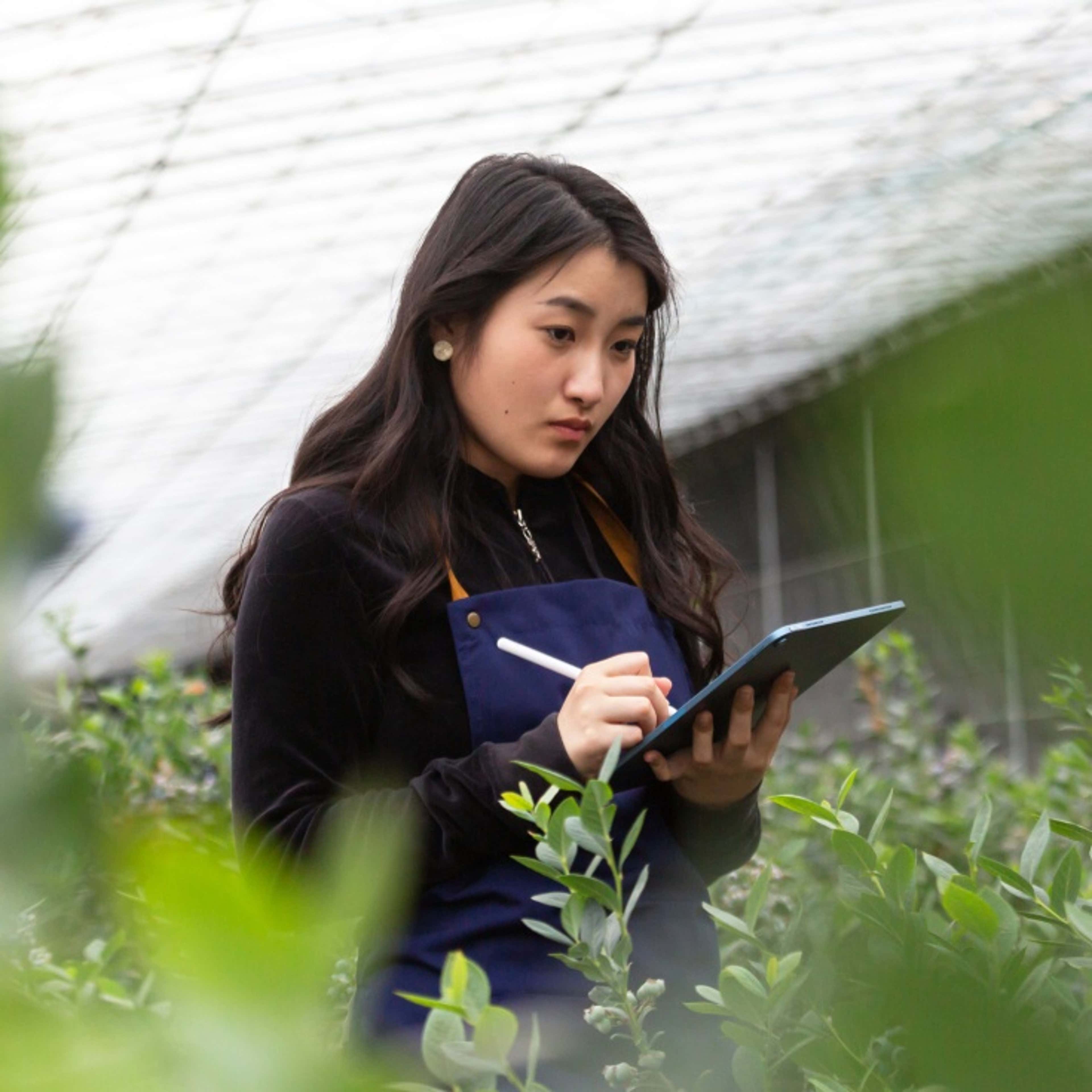 Woman observing plants